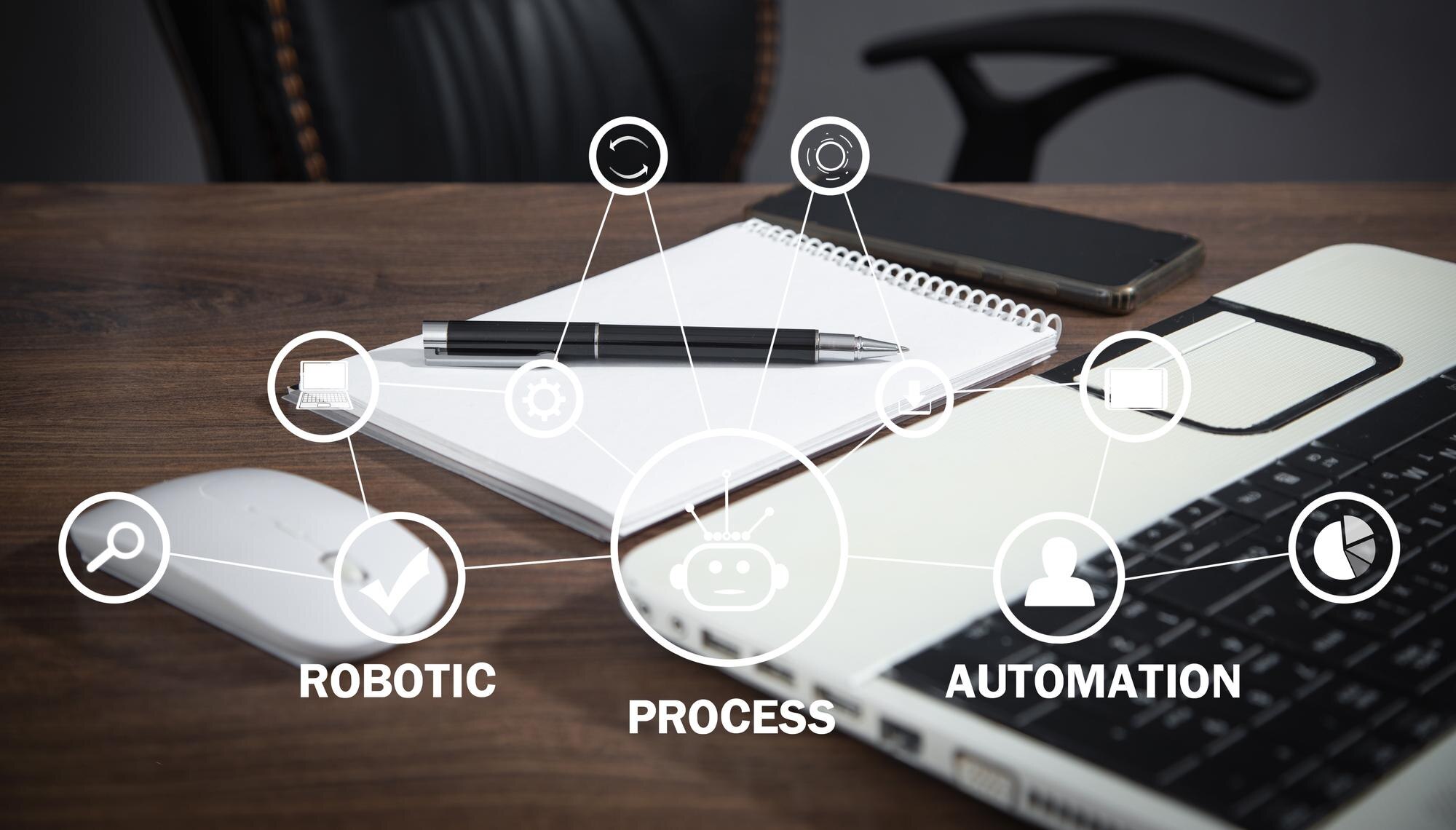 brown desk with a iphone, spiral notebook, pen and white mouse and laptop sitting on it. Overlay of graph that shows Robotic Process Automation