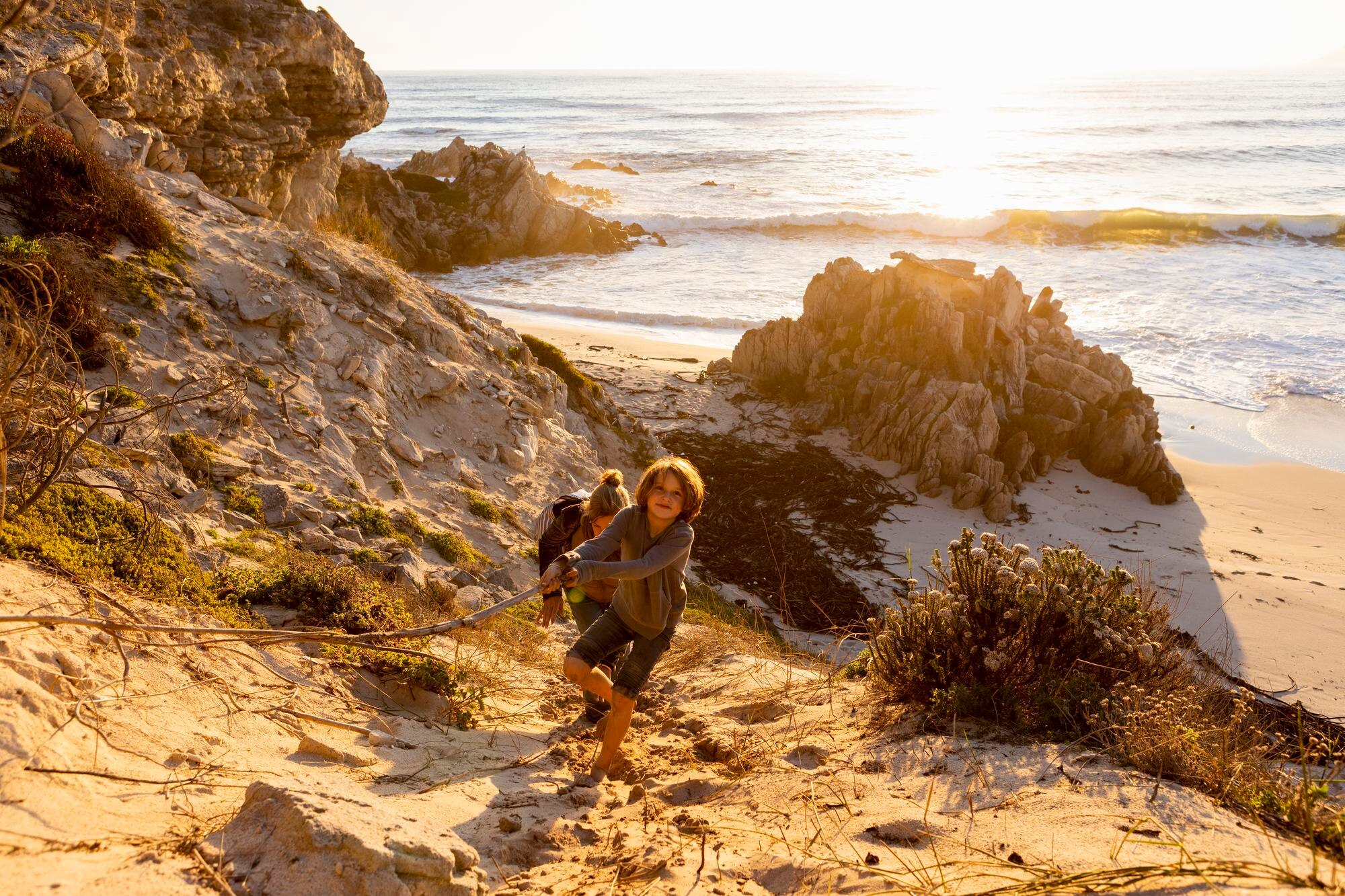 a boy and a woman clambering up a very steep sandy 9bbabf02c63c2882afb9 BTOURS