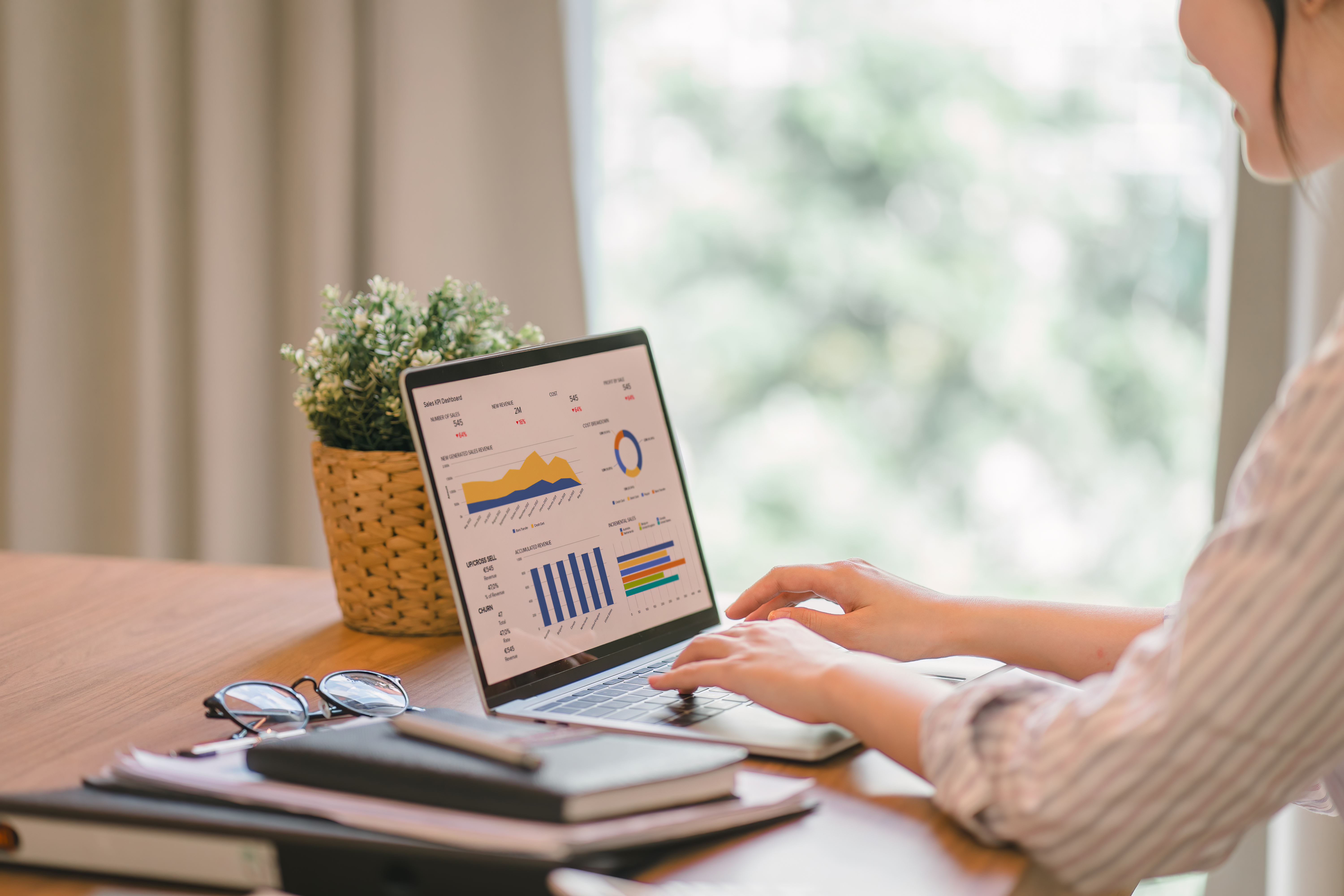 Person analysing digital marketing charts on a laptop to improve SEO performance.