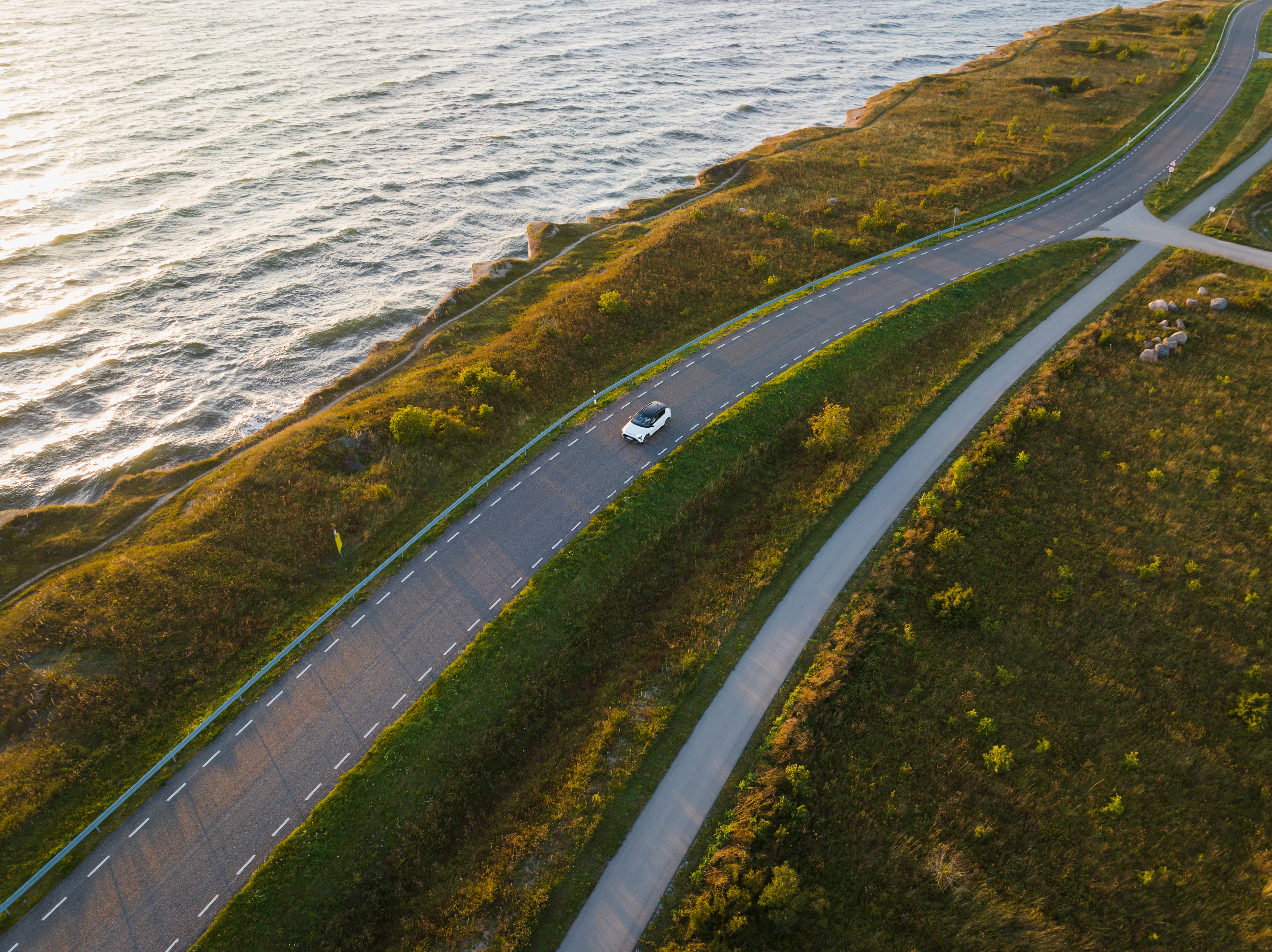 Crafting Your Perfect Self-Drive Itinerary: A Step-by-Step Guide 5 a car drives along an asphalt road on a steep seas 08c7f891366e9a7757b8 BTOURS