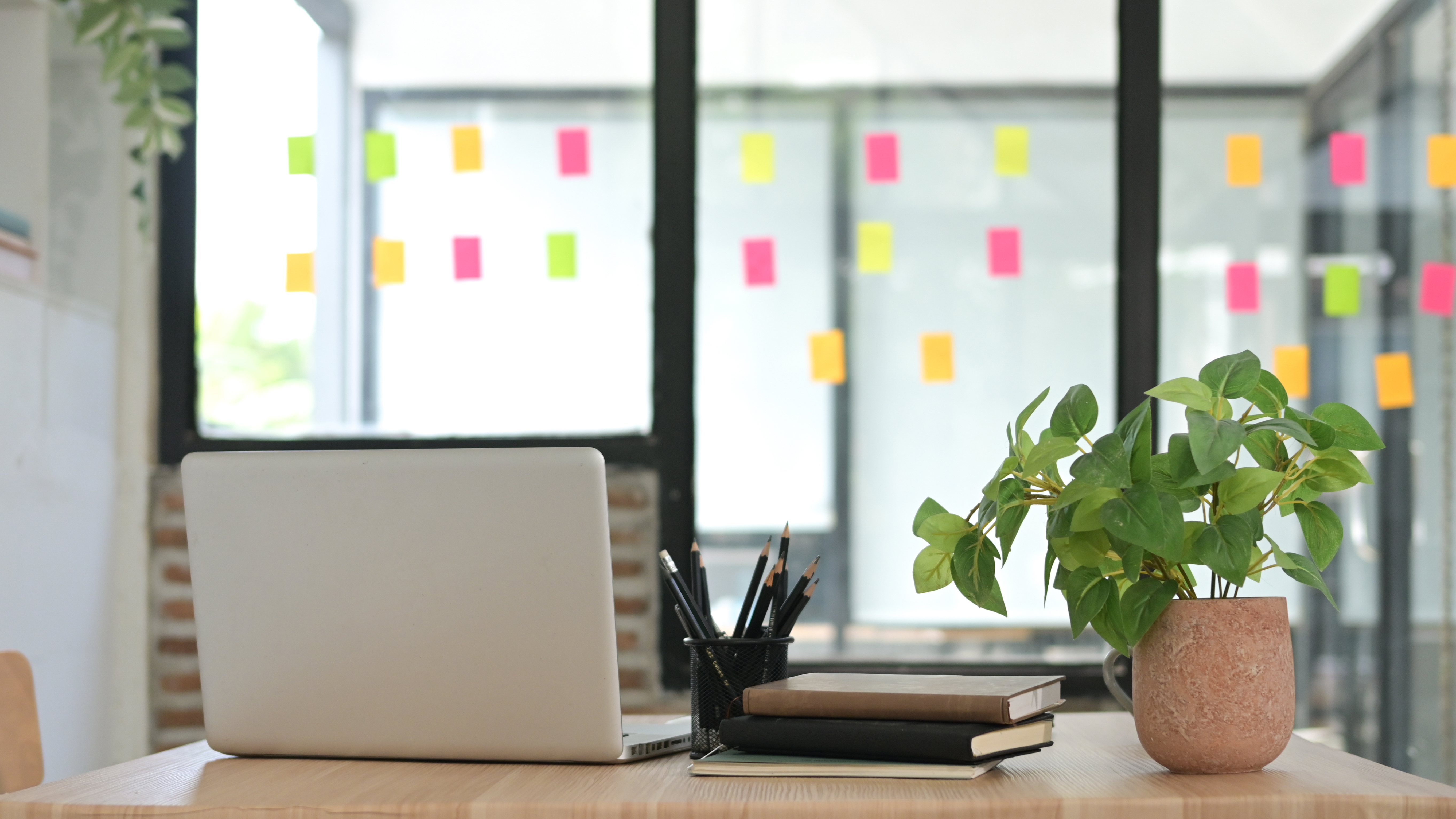 Integrating Personal Growth Into Your Professional Life: No-Nonsense Strategies 2 A Desk With A Laptop A Potted Plant And A Stack E69Cbb4C34440E439843