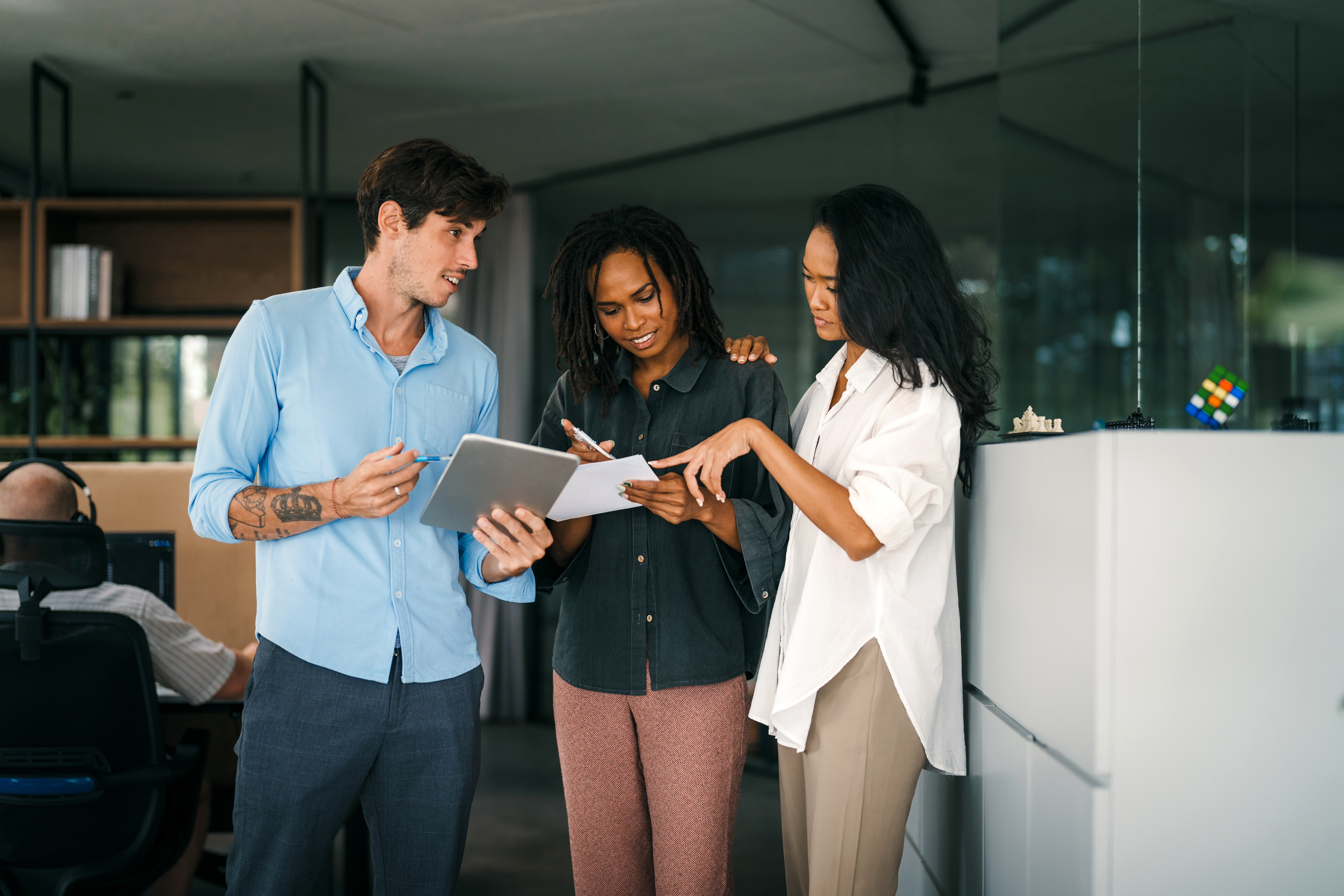three professionals reviewing papers together in an offide