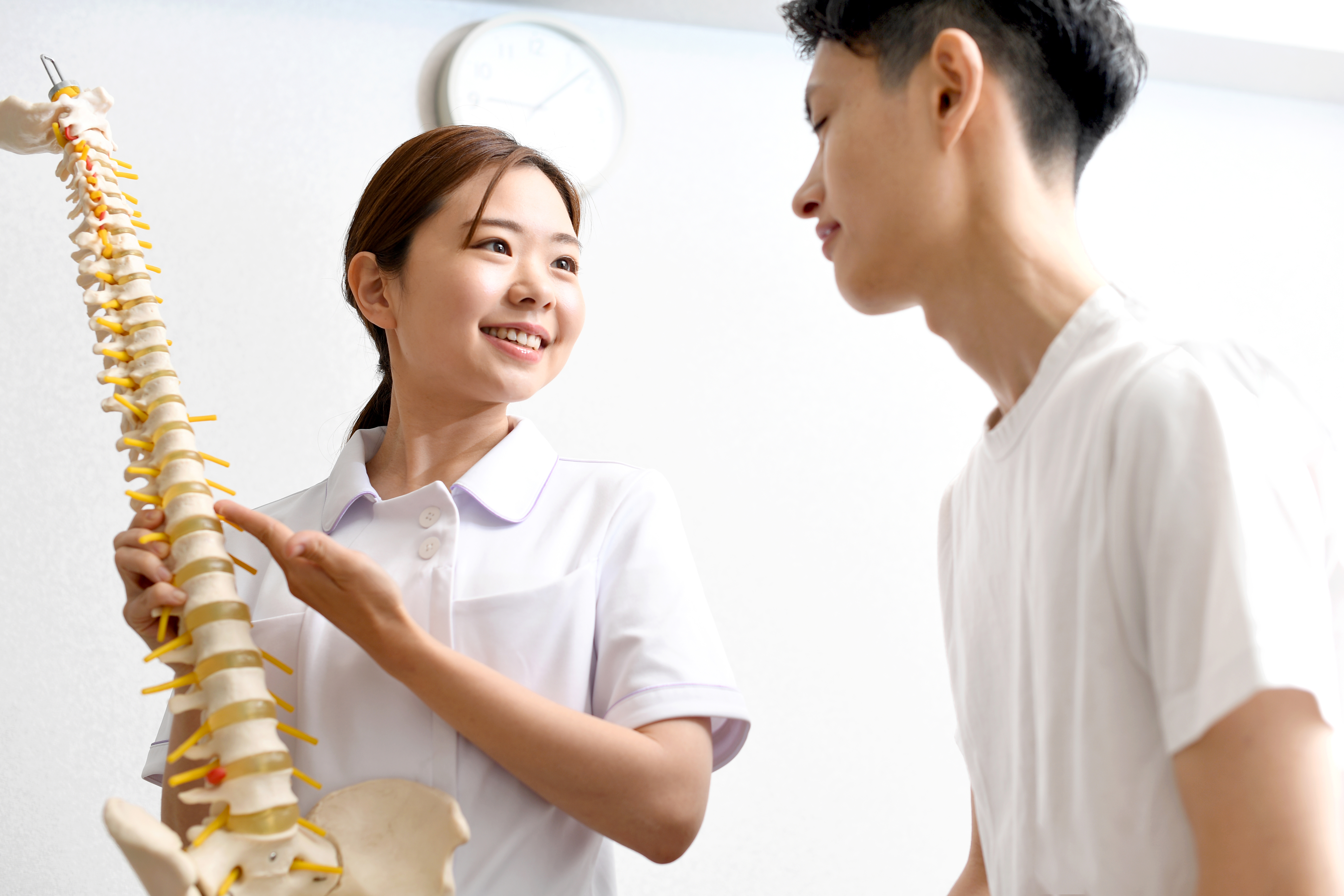 a female medical worker chiropractor wearing a w 1ad21efcc94cc65d0723