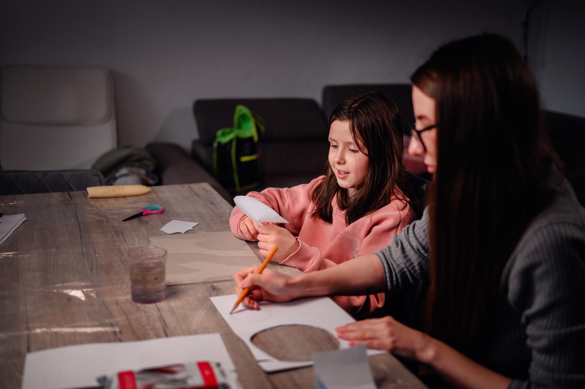 A Focused Young Girl And An Adult Woman Engage In 1df67eba54a5ff4d3507