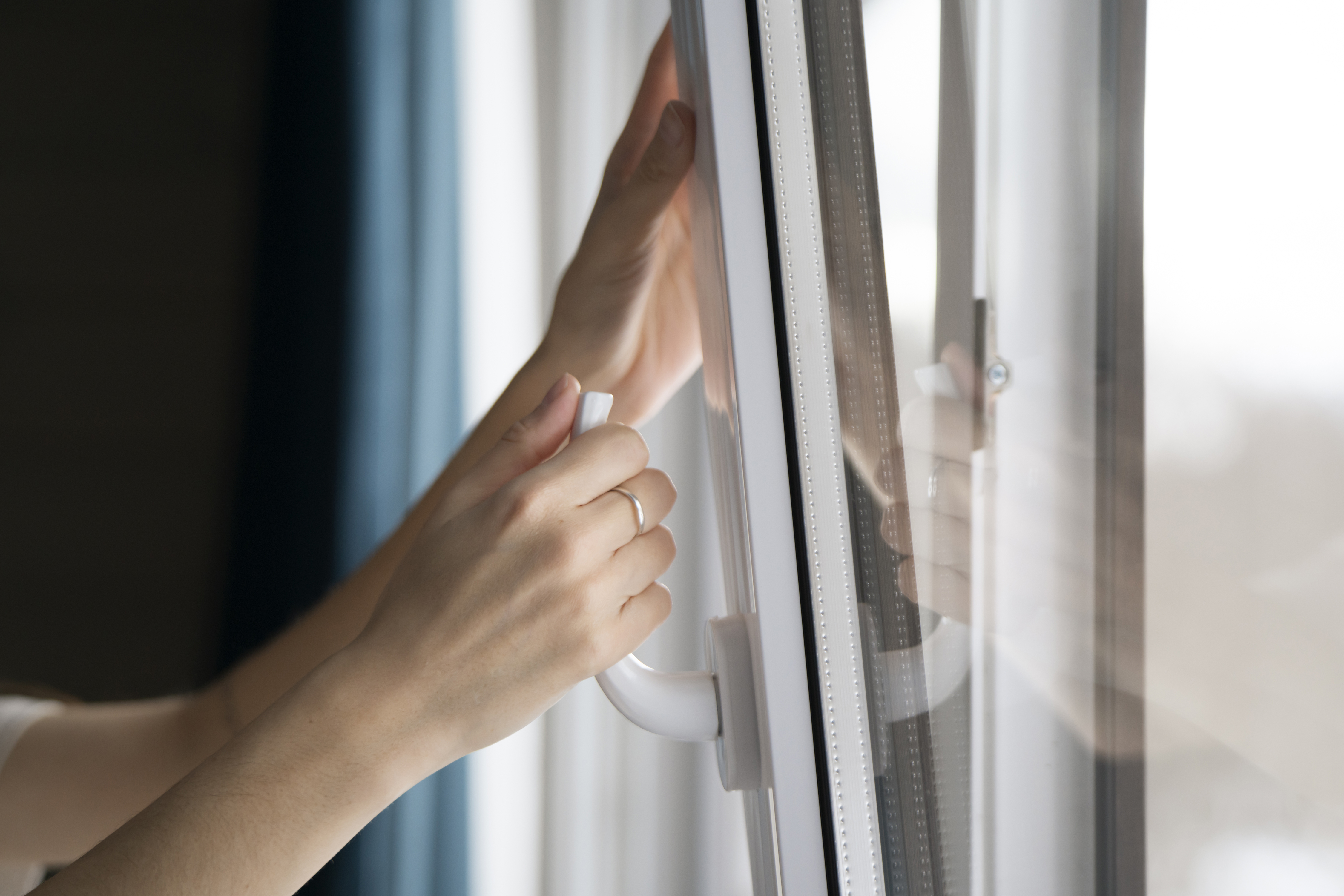 a focused young woman is seen opening a window in fd69a797920c9a12143f