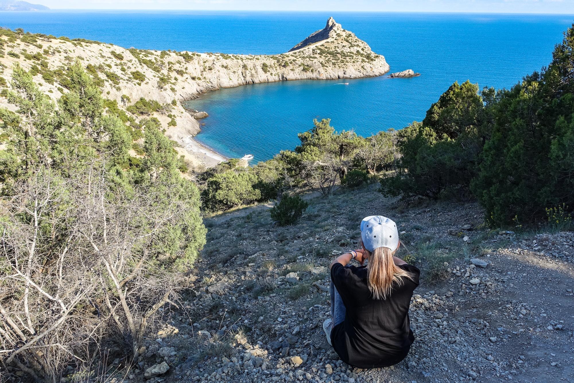 Sleep Well, Explore More: Why Handpicked Stays Elevate UK and Greece Road Trips 3 a girl on the background of a panorama of cape kap b15c82a2eda38991d4f2 BTOURS
