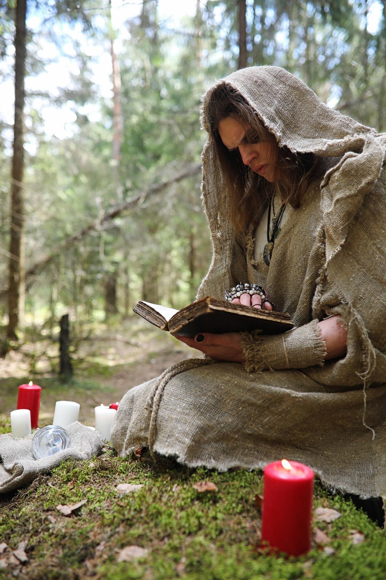 a man in a cassock spends a ritual in a dark fores 07ac39ae412eae7dfe00