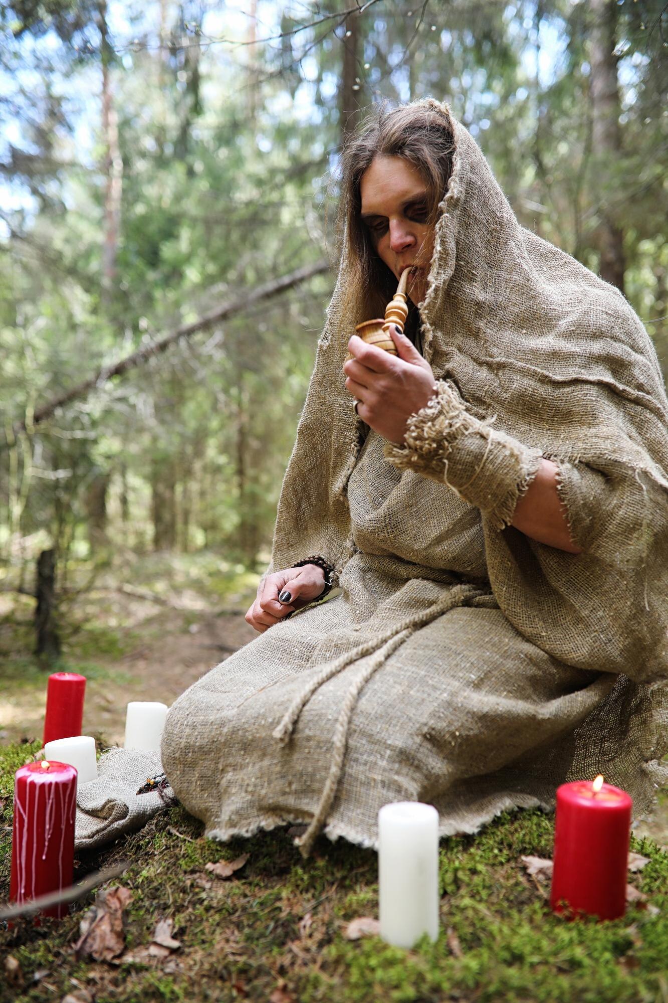 a man in a cassock spends a ritual in a dark fores b7f40afec3eac99f21d1