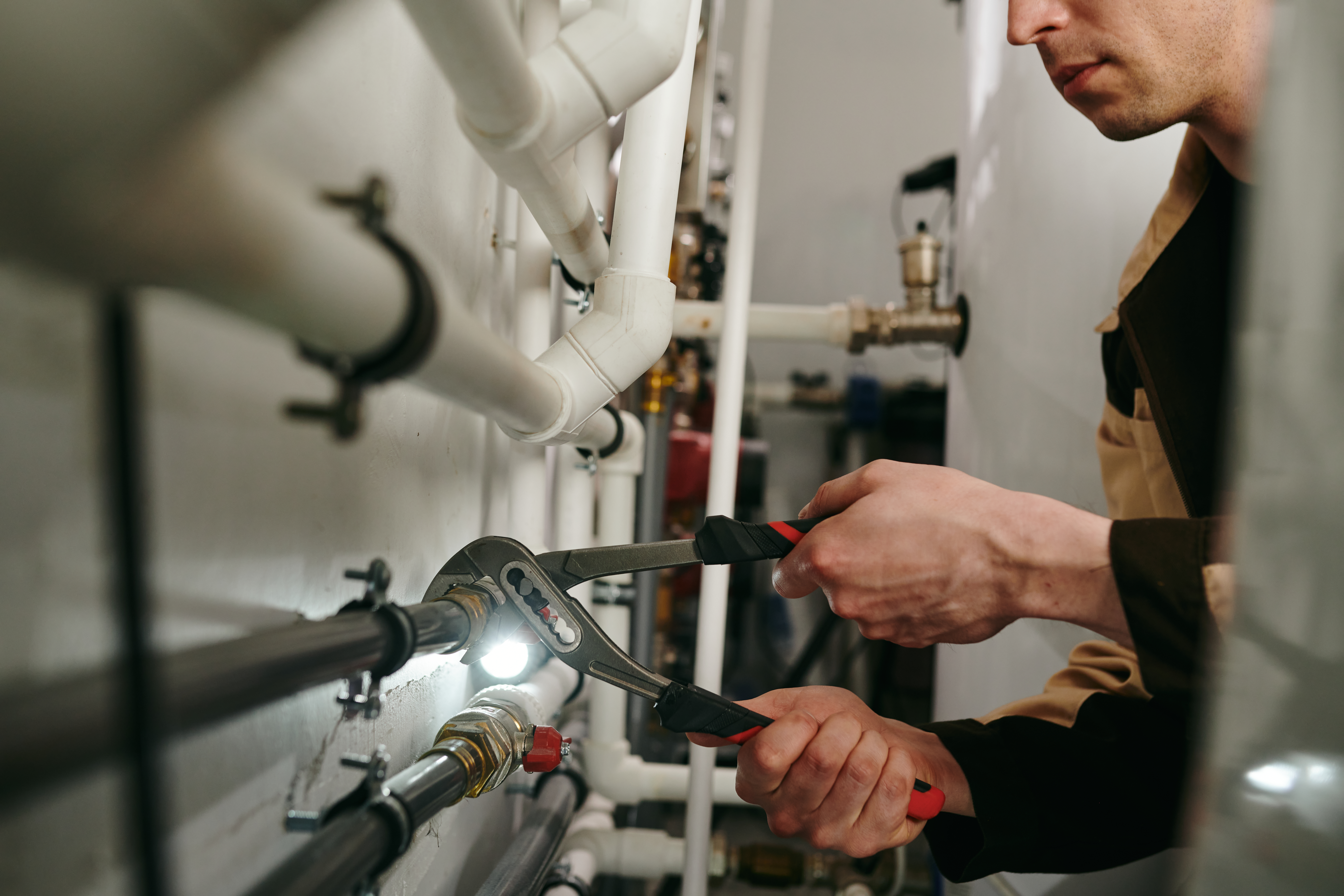 using wrench to tighten pipes