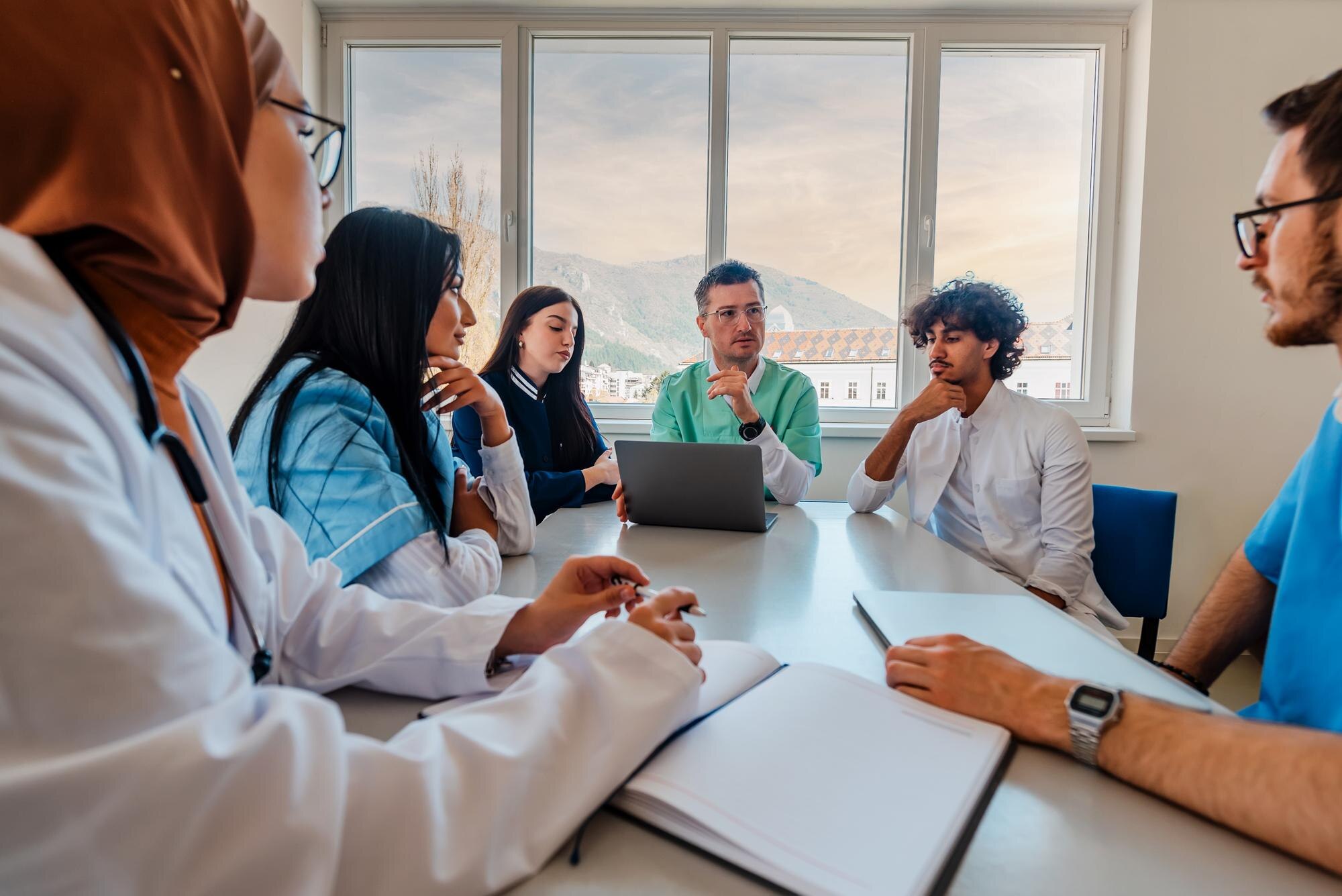 How Personalized Guidance Transforms Your Licensing Journey in the UAE A Medical Team Of Doctors Discussing At A Meeting 7118c655400f57157e1a