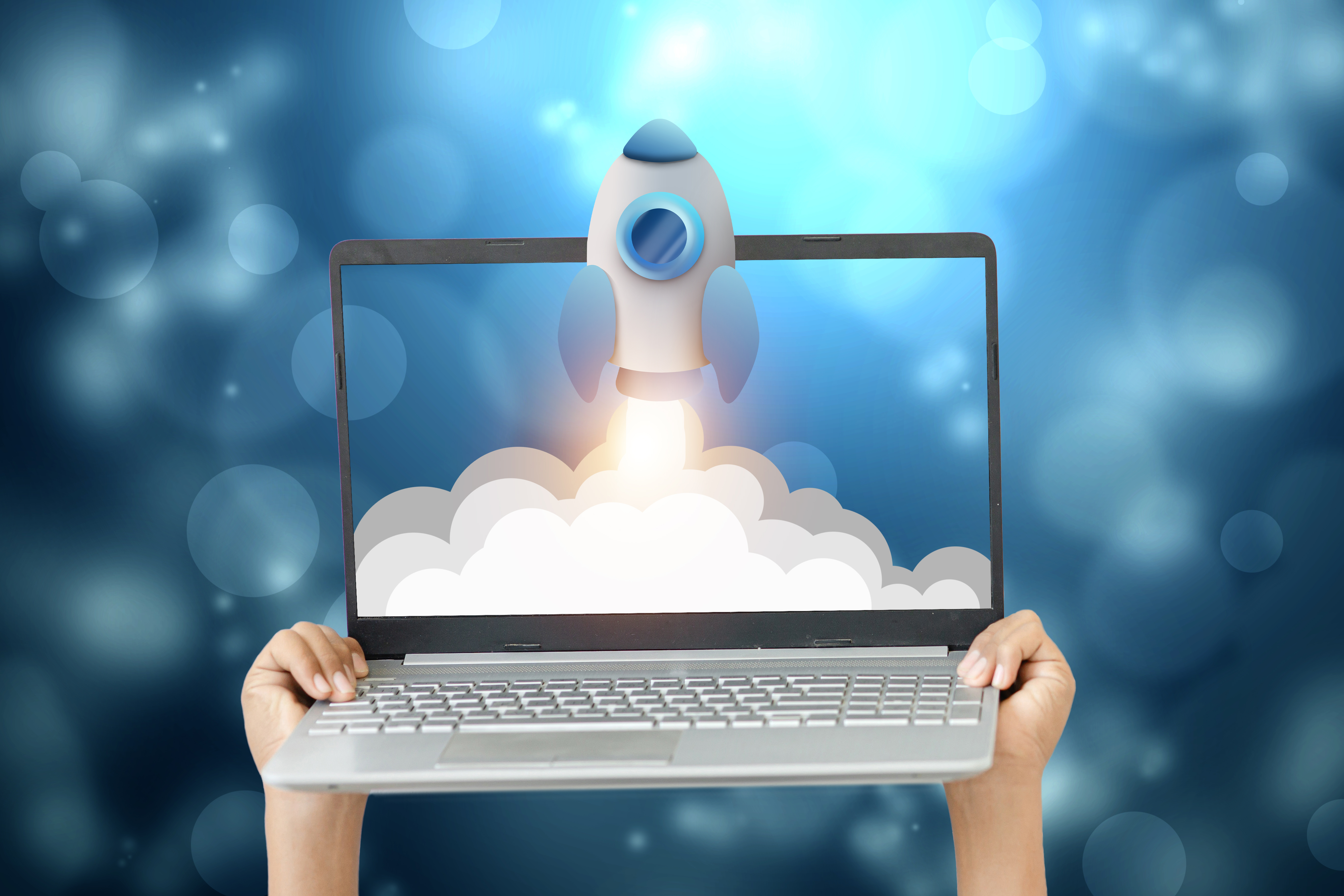 a person is holding a laptop with a rocket on the bfc3408d5366e941b645