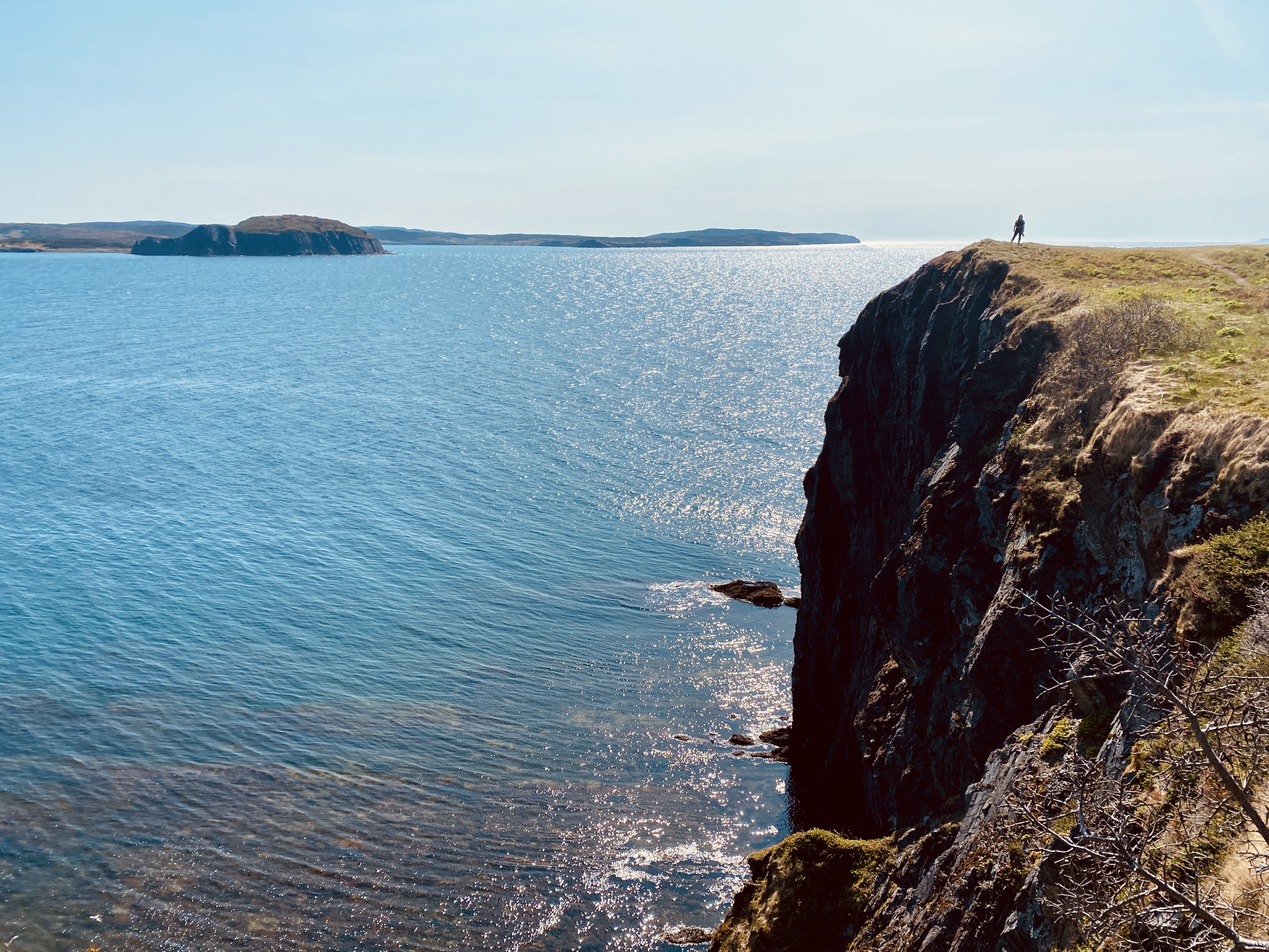 a person on the edge of a cliff admiring the spark 648a1c1a51c25f9c6755 BTOURS