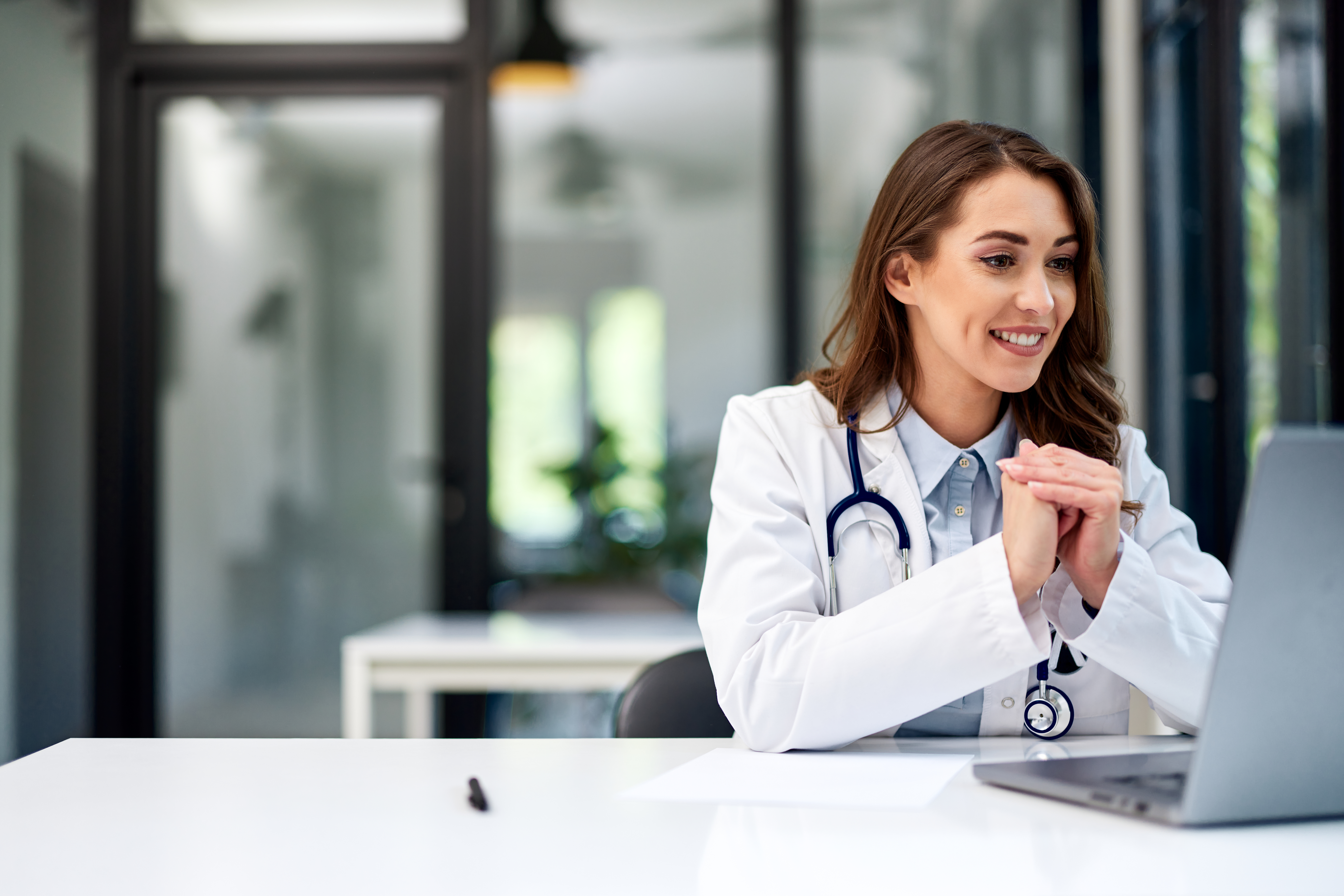 a smiling female doctor having an online video cal 8b8f5152997393023aa1