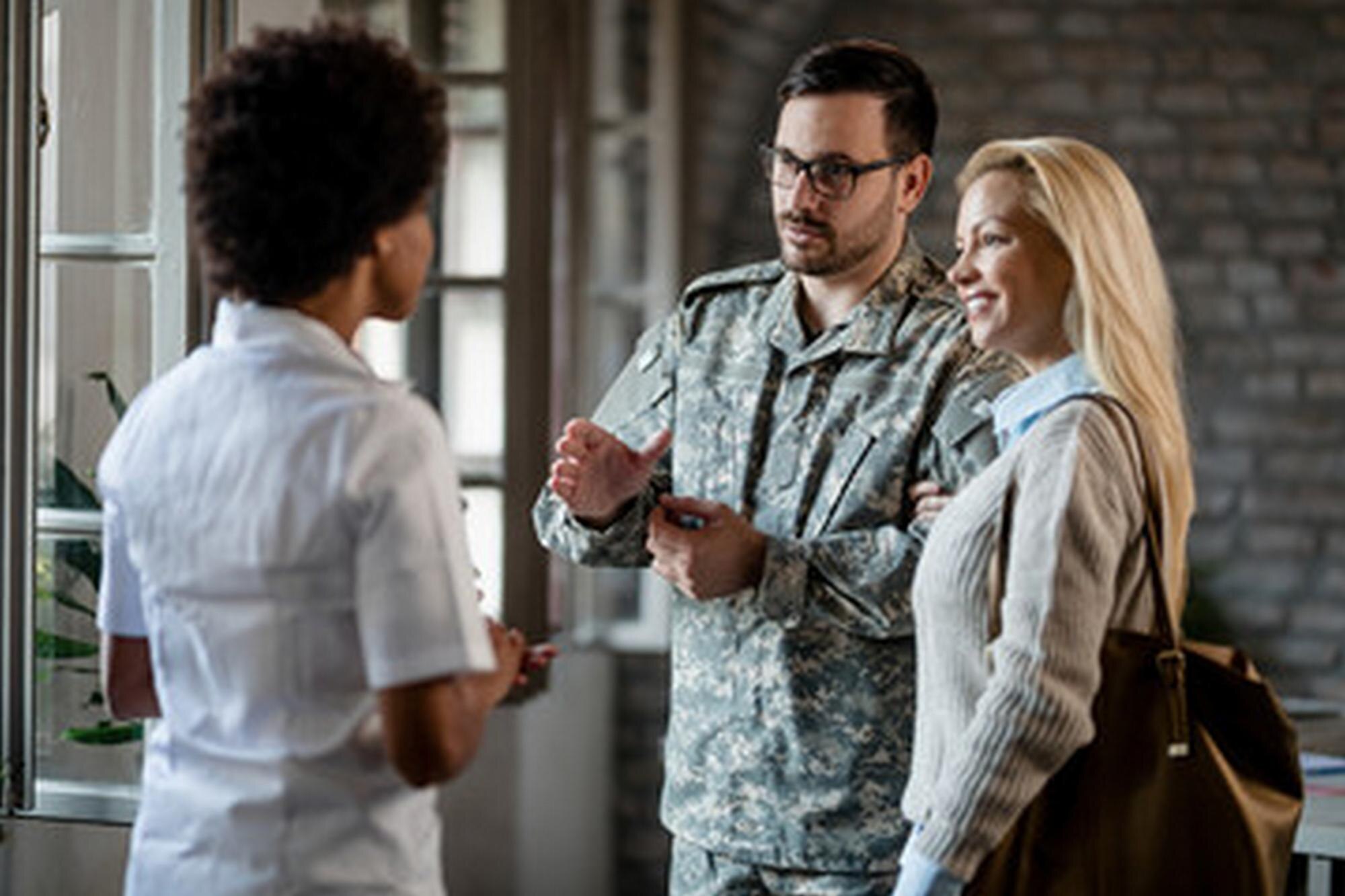 Soldier in military uniform discussing with a woman, highlighting legal support for military families during divorce consultations.