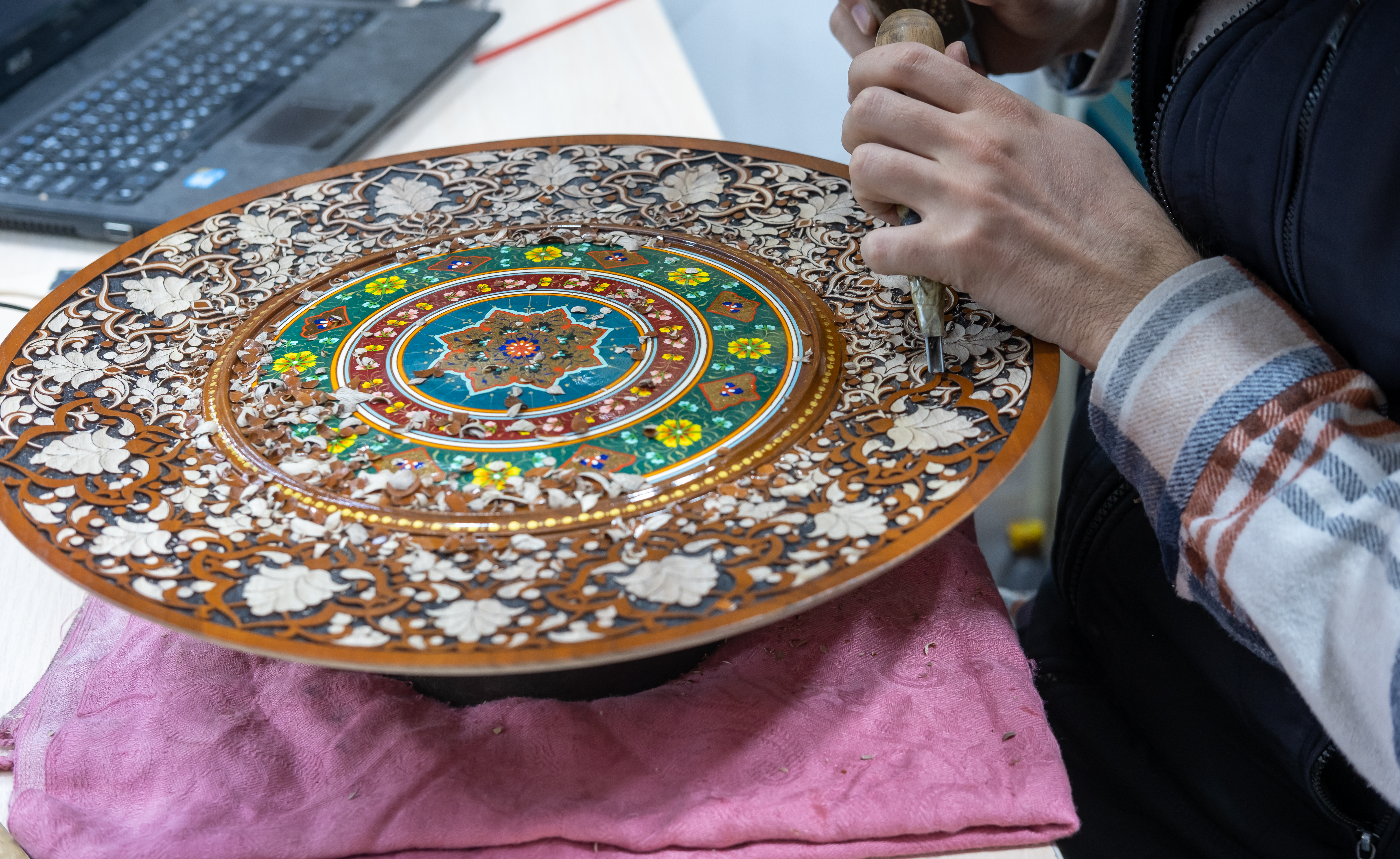 a talented craftsman working on wooden plate 4b7f5f08b3157c04a001