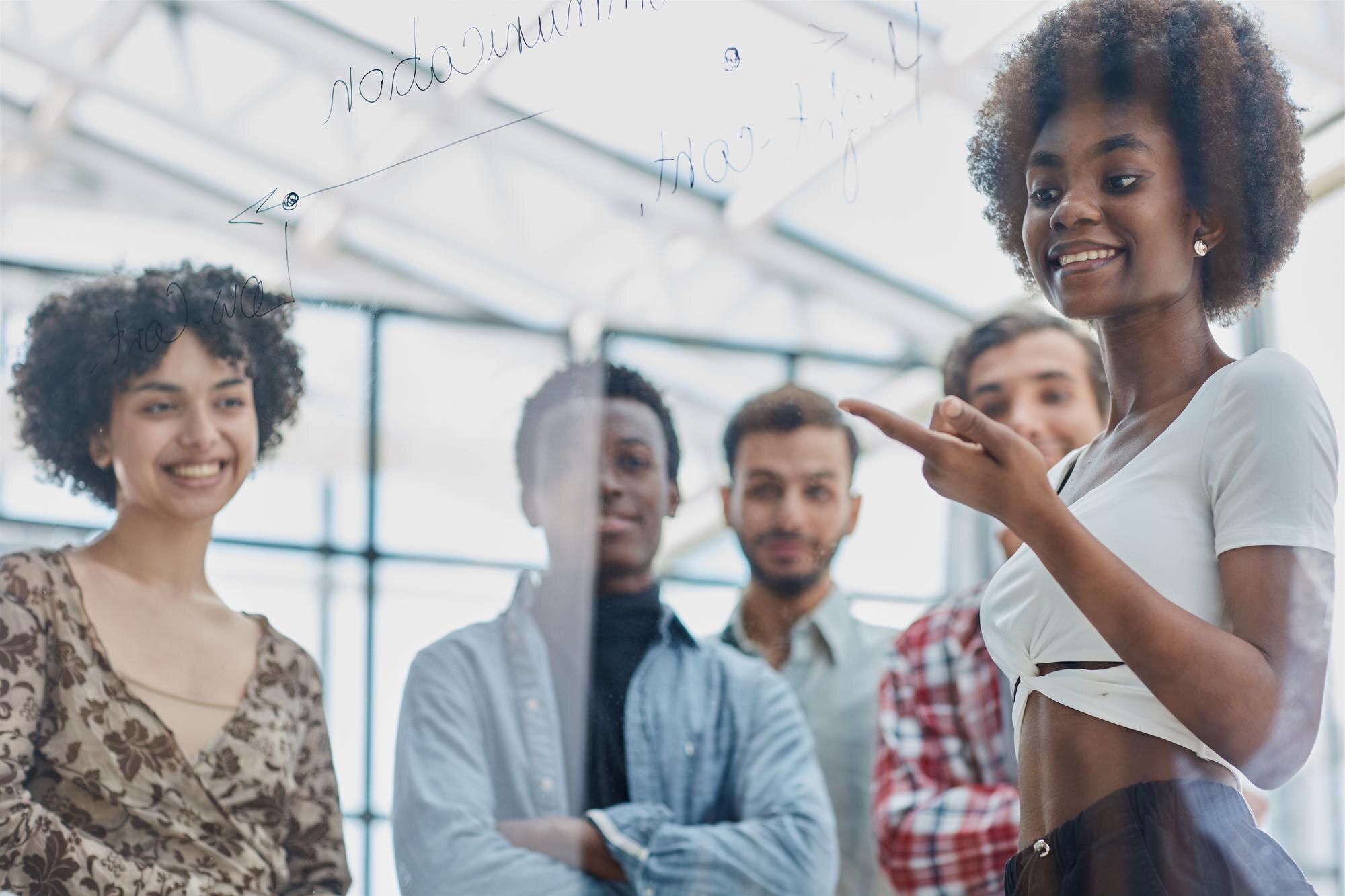 Unmasking Imposter Syndrome: Stories, Struggles, and Science A Team Of Young Designers Sticking Notes On Glass Ff2b2d765fd6e69248cc