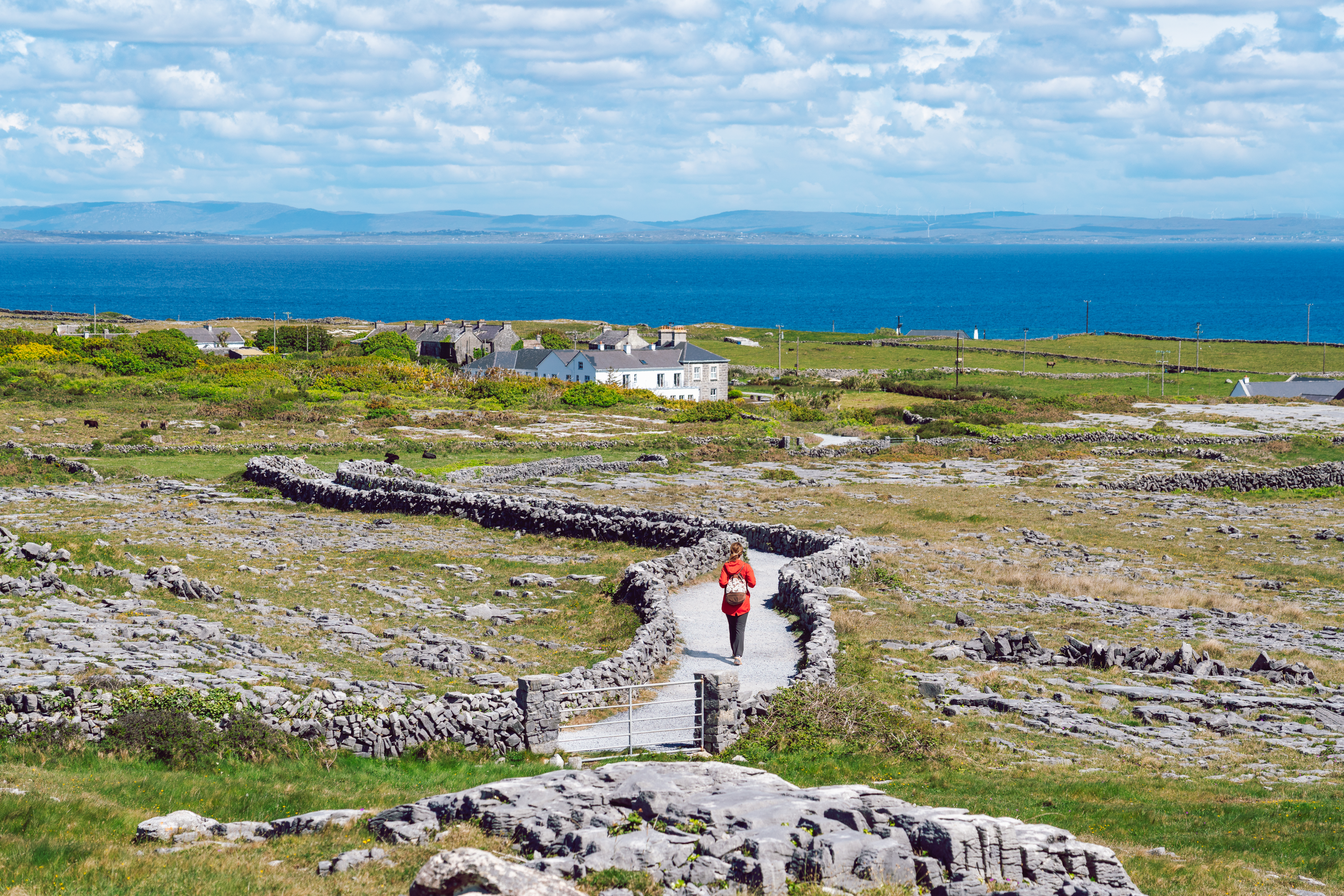 Slow Roads, Secret Ireland: A Self‑Drive Guide to Hidden Gems 3 a tourist walking a trail on inishmore on aran isl 887c09d036c95857d060 BTOURS