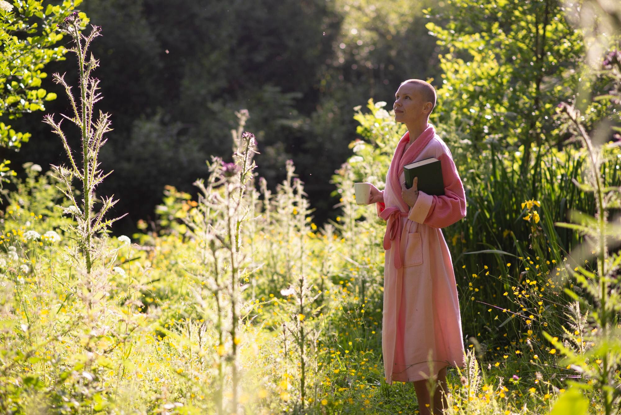 a woman with a shaved head in a pink robe in the w 3372dc7b8ab64817564b