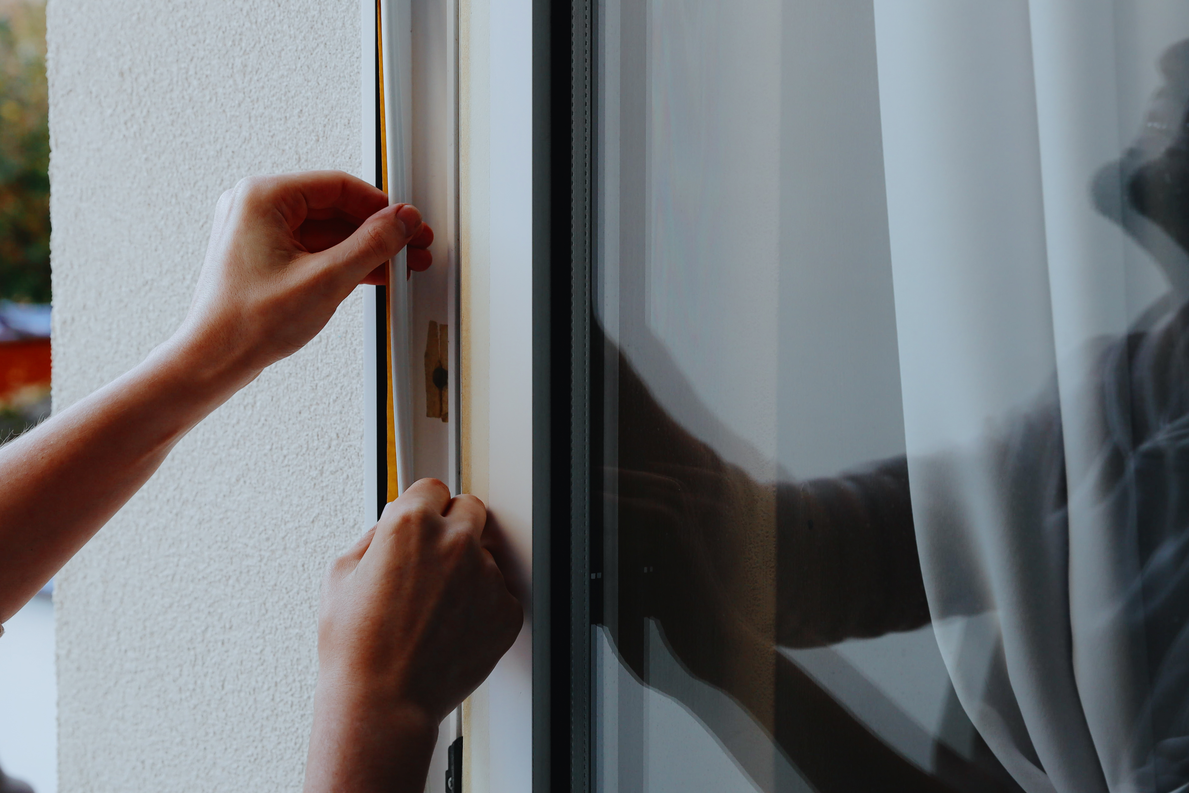 Cheap plastic sheets cost more: The hidden costs in construction and DIY 1 a young man has his window frame insulated 482cd97fed605af1bb9b