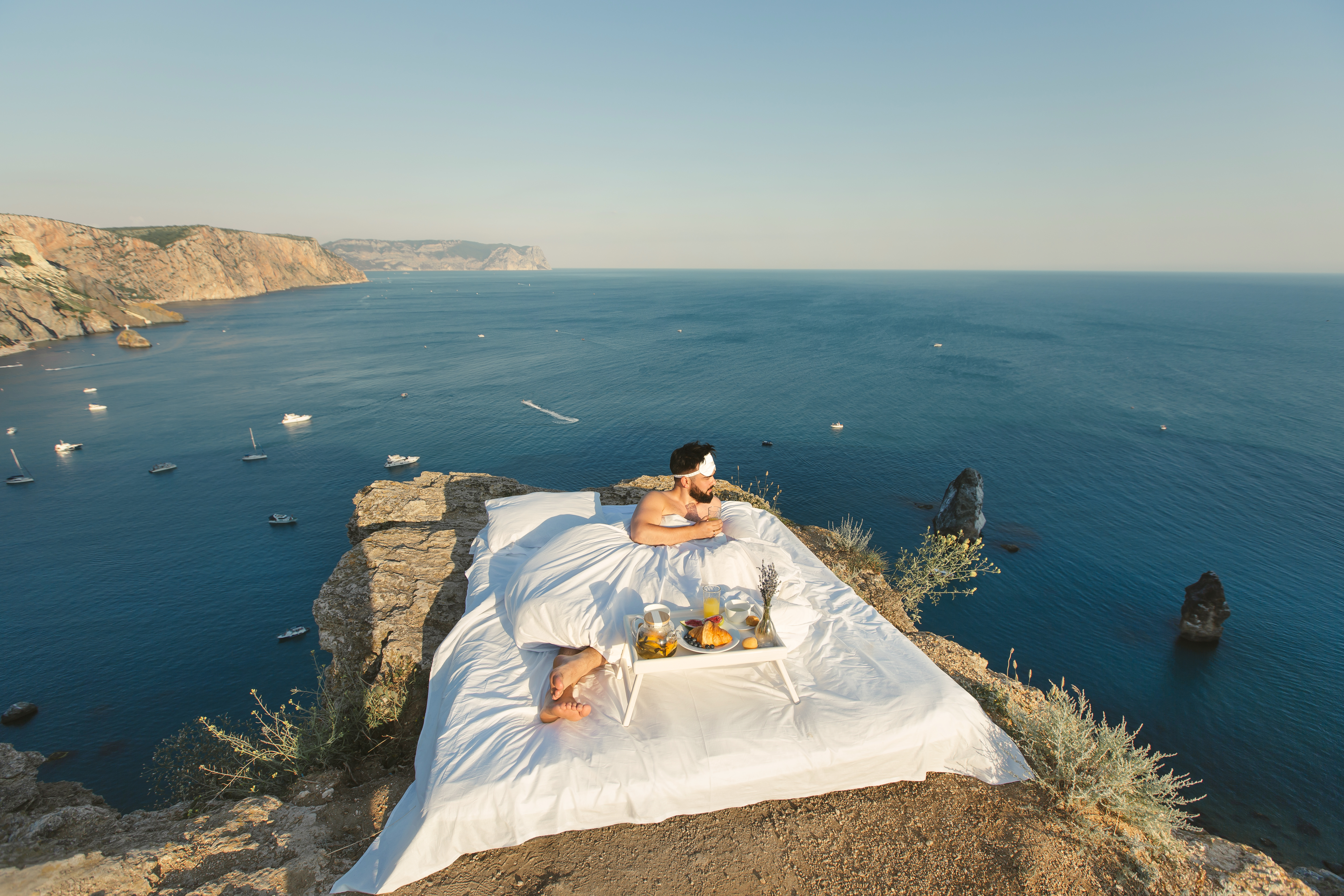 a young man wakes up alone in a white bed on a cli febaa40cb55e0b5a5235 BTOURS