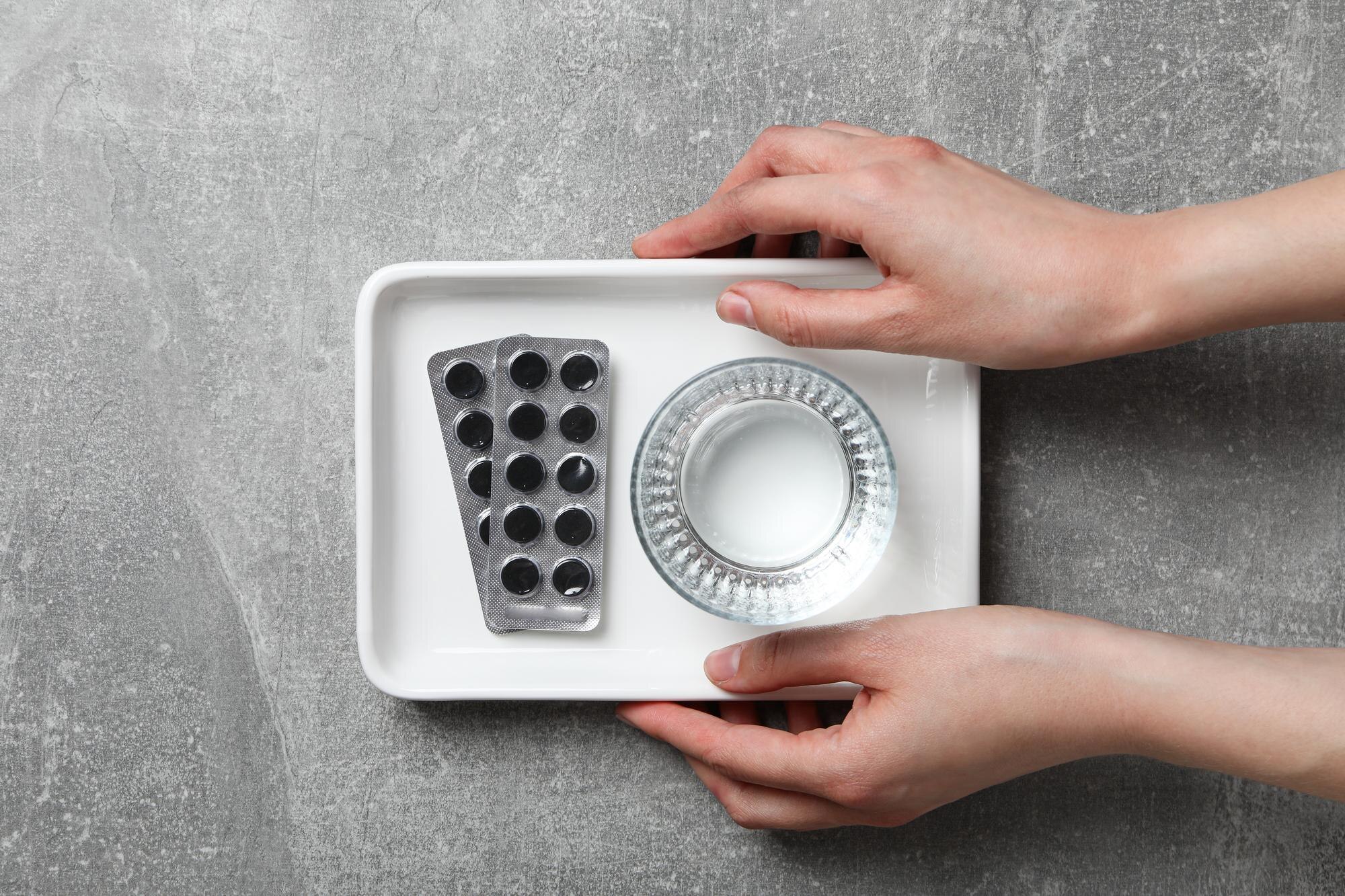 How Vacuum Forming Enhances Custom Plastic Product Design and Functionality 3 activated charcoal tablets and a glass of water in b6debb5386cc1416b76d