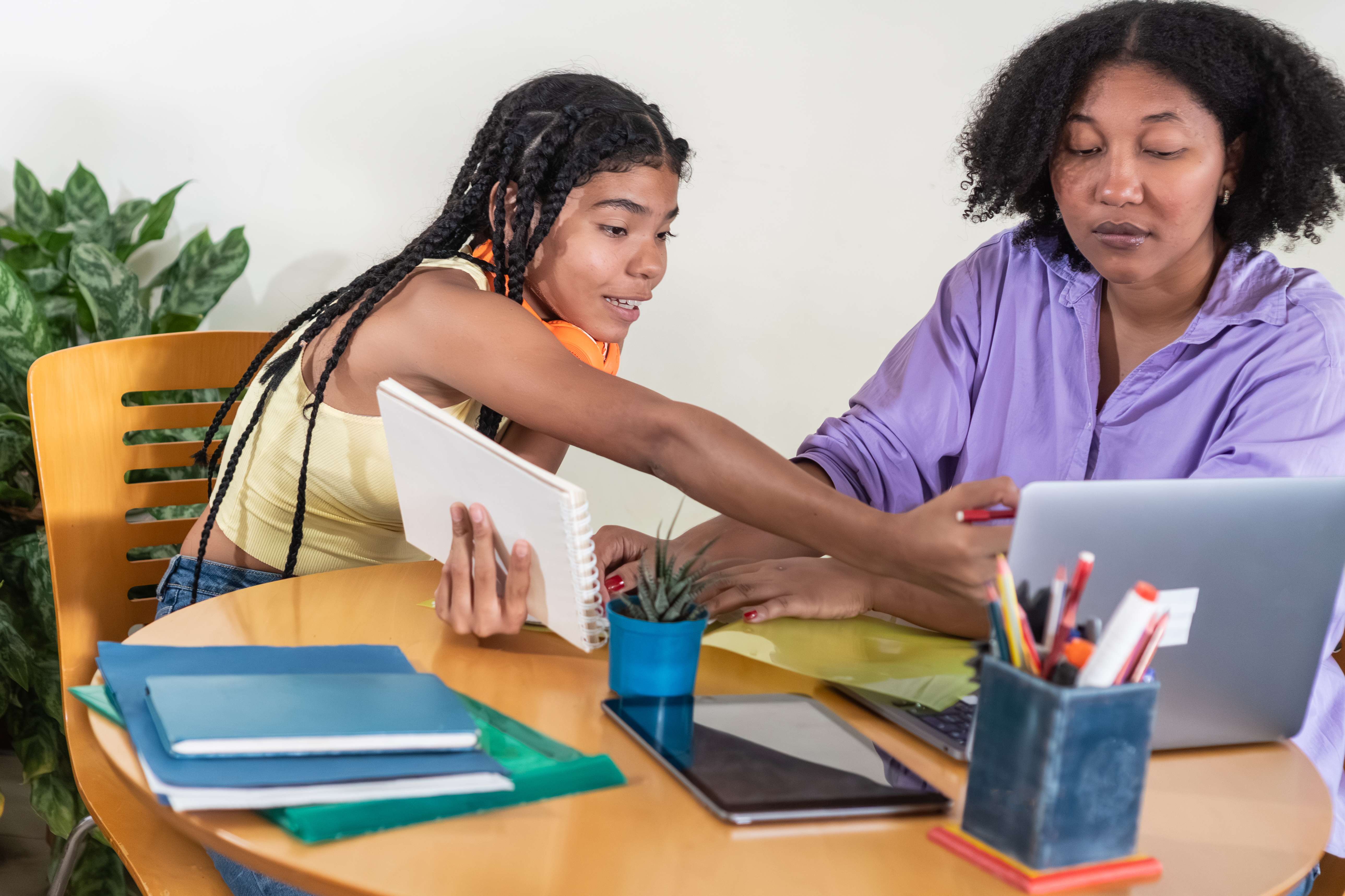 Adult Woman Helping Young Student With Her Studies E24644102aca09b33518