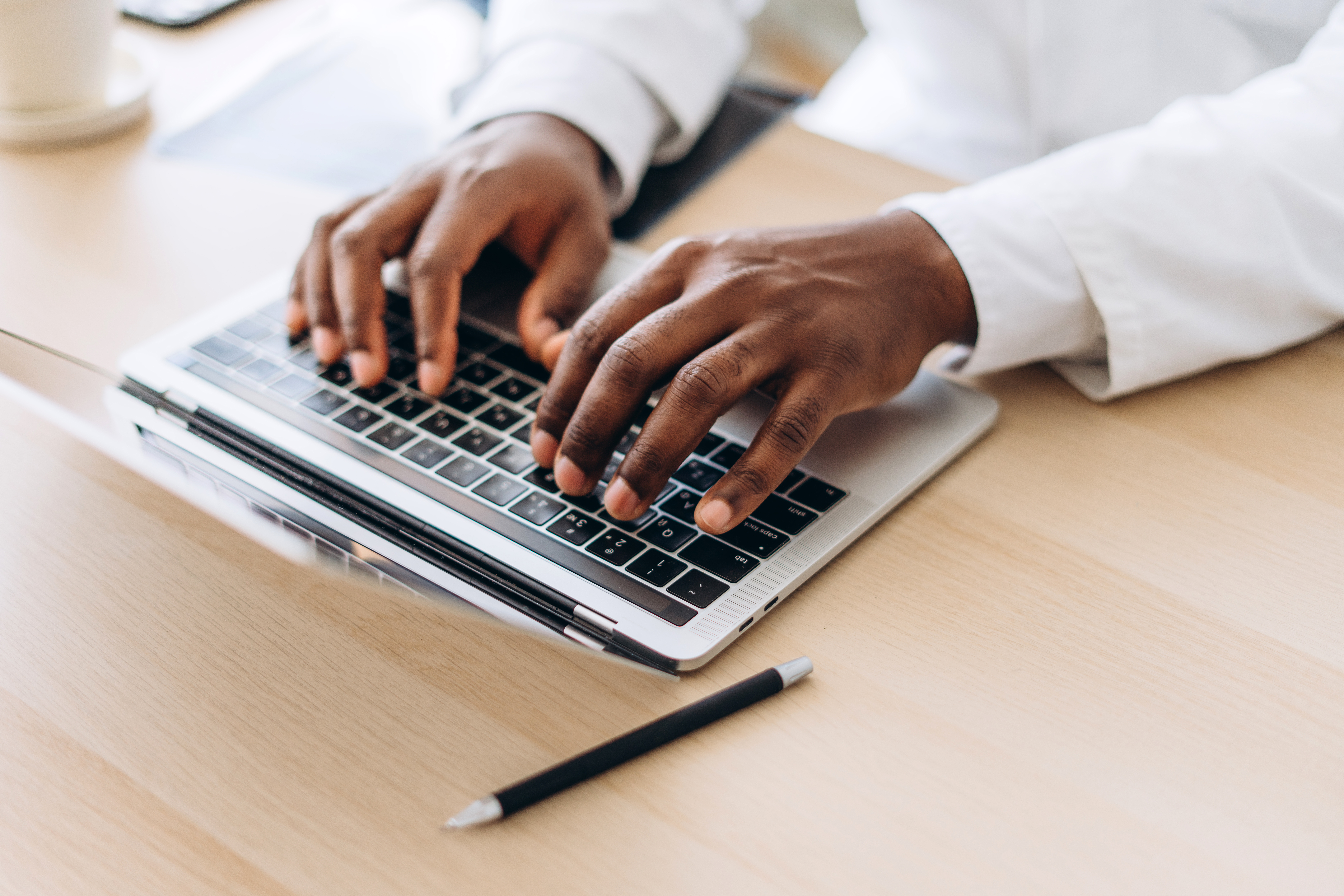 african american doctor hands typing on laptop in 25e2b7cb38d94d9f3b91