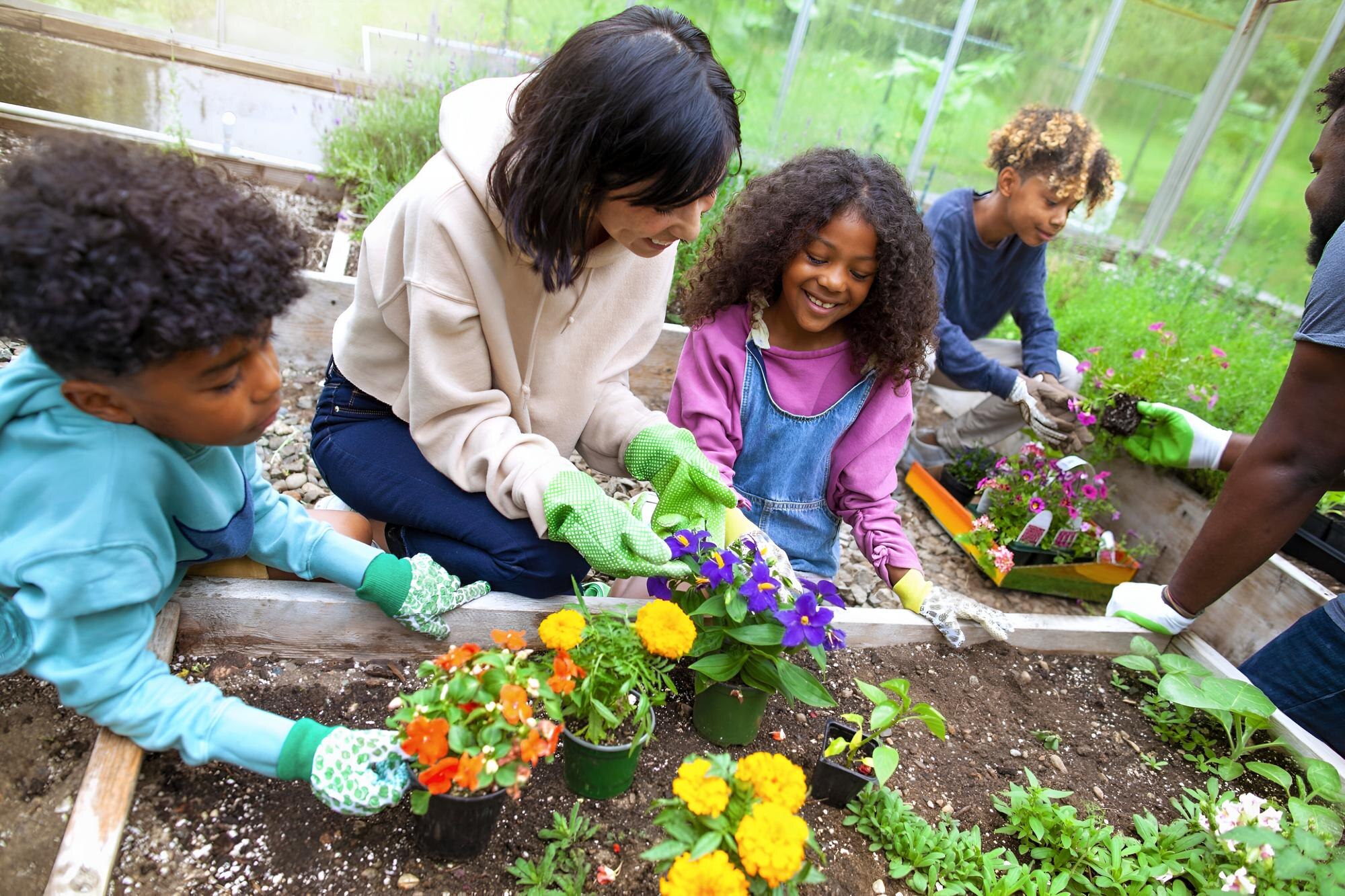 Growing Together: How Sustainable Gardening Sprouts Community Growth African American Family With Three Kids Working At 599c8bc7f3afaabdd4e5