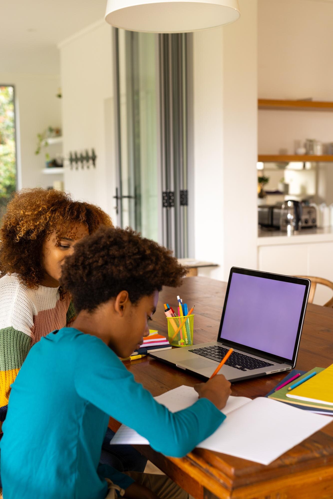 African American Mother And Son Using Laptop With E41561421c3f3ef30653