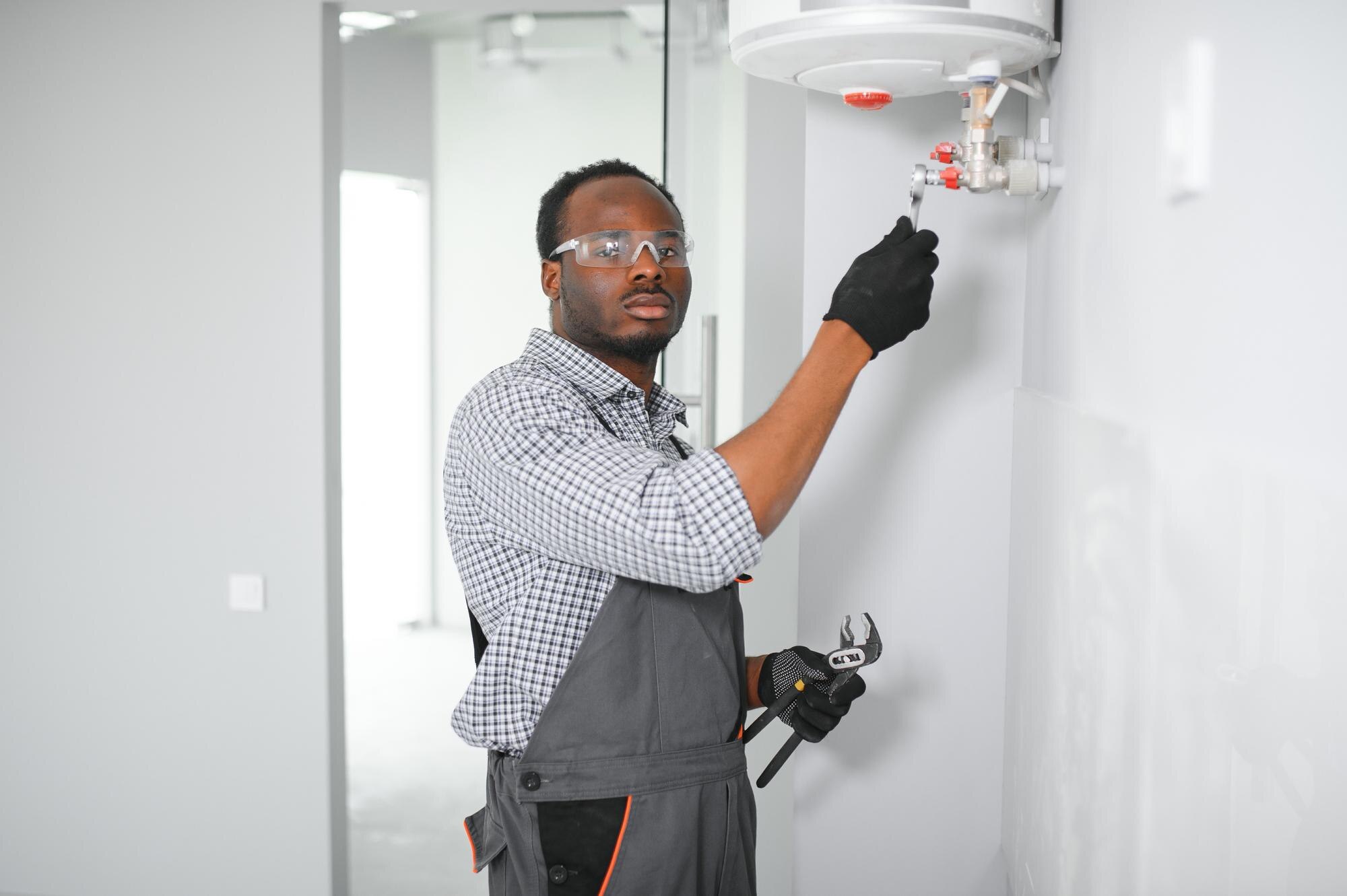 Man working on tankless water heater