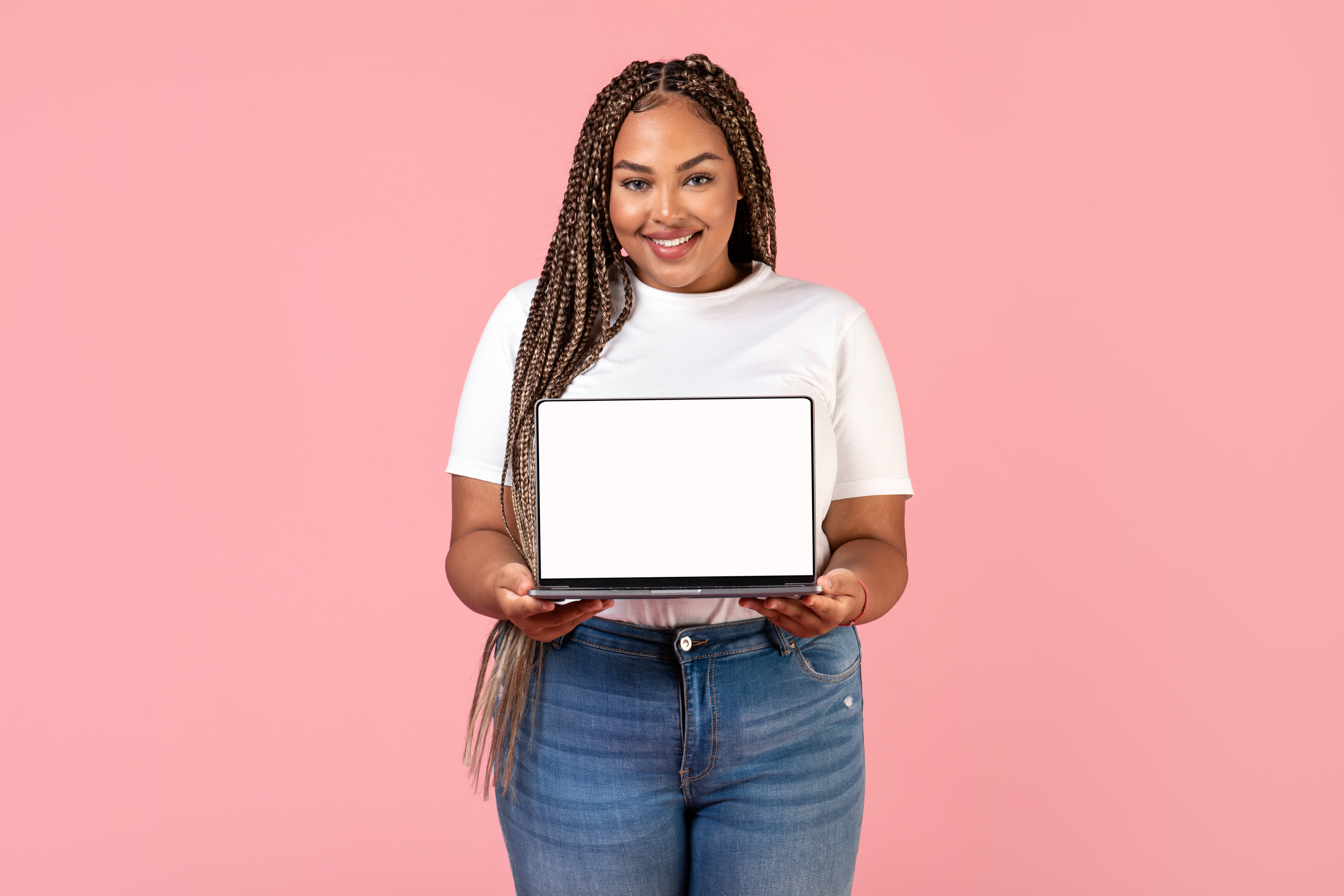 african woman holding laptop showing blank screen 8b4c5e693a74c98fcc7a