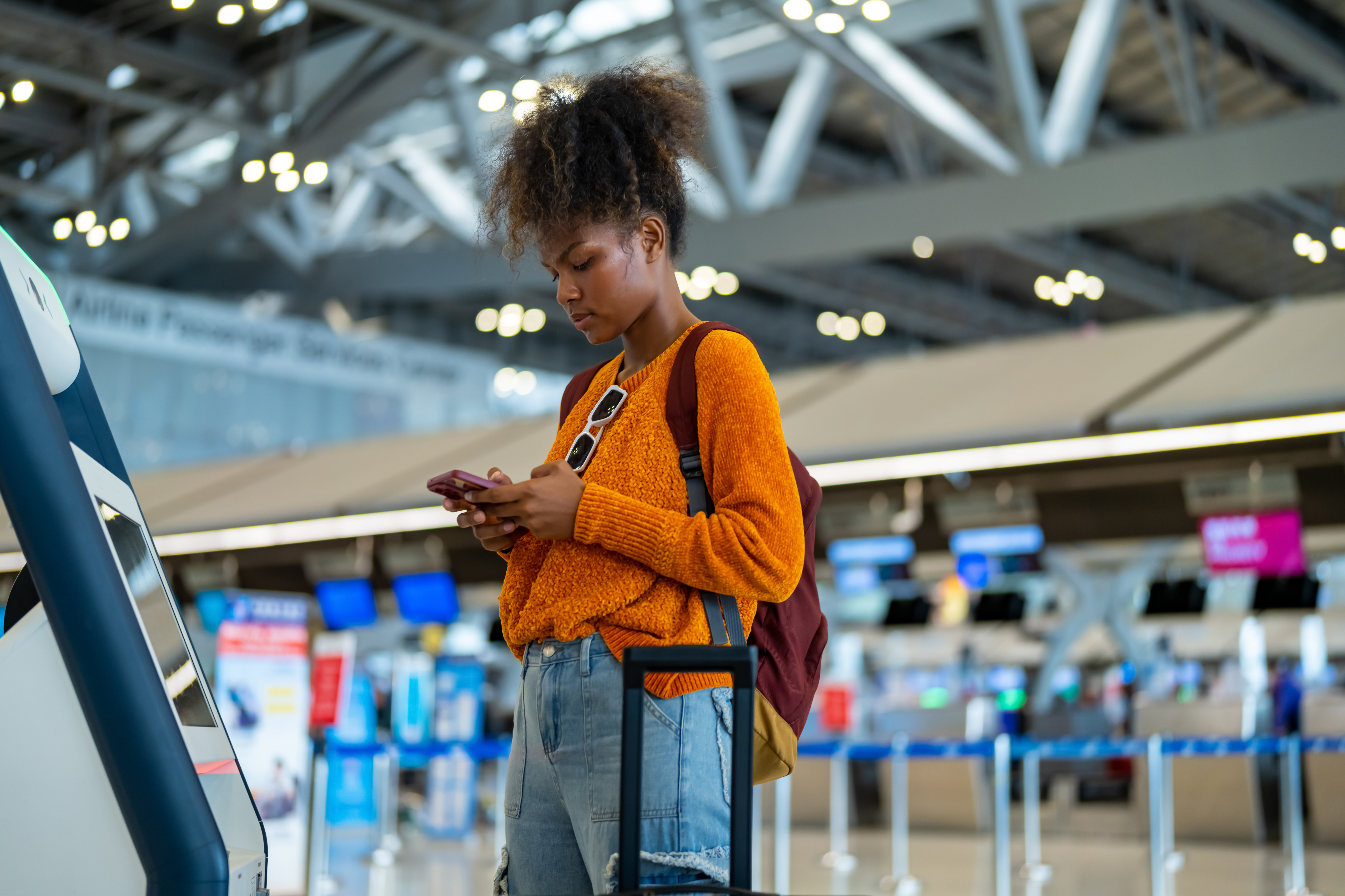 Quick Tips for Managing Your eSIM Data When Traveling Across Multiple Countries 3 african woman using self check in kiosk machine at 0f0e9774fc804b9a855e
