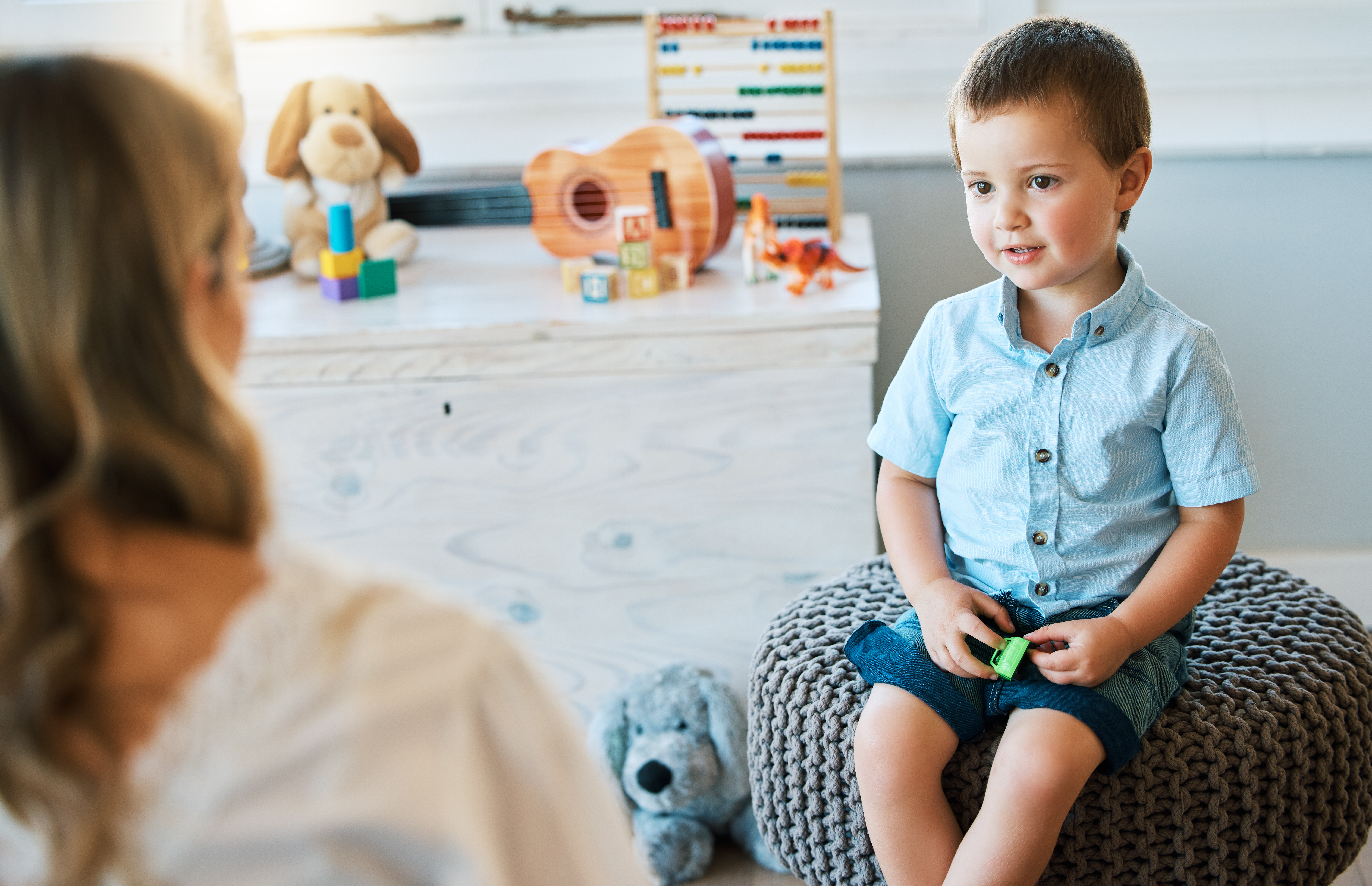 an adorable little boy sitting on a chair while ta 63b02d5517561a78166e