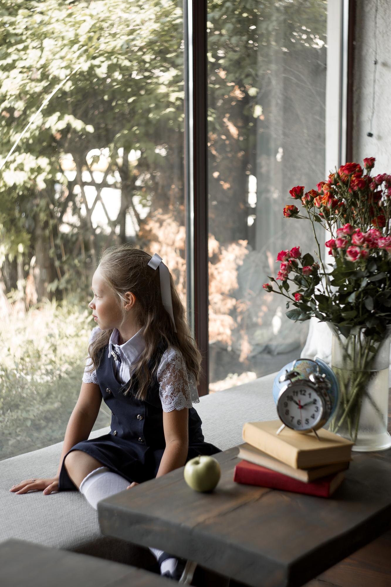 An Elementary School Girl In A School Uniform Sits 04ebbbf6bfe20474134c