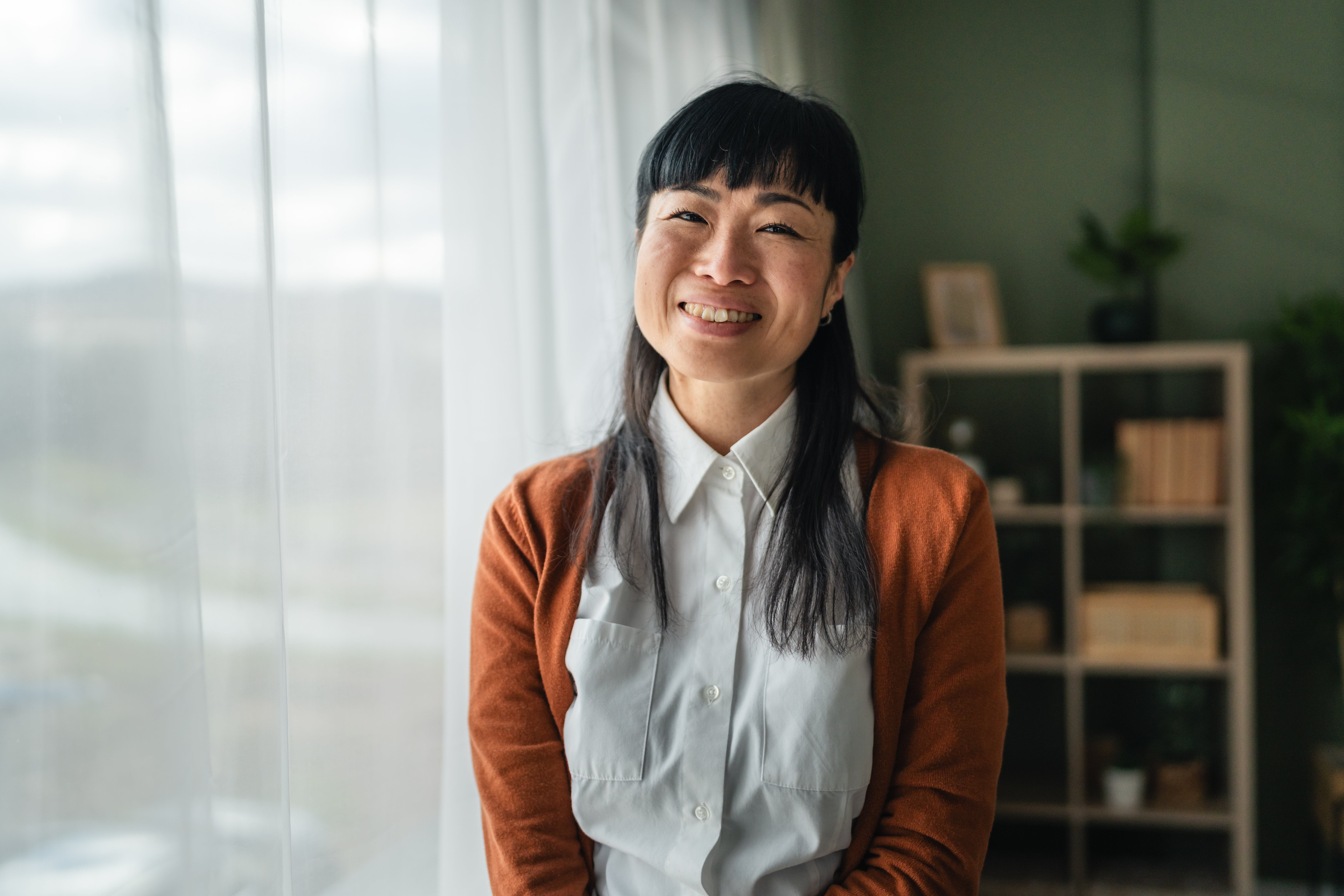Asian Woman Smiling With Natural Light At Home D313743bb248e1129dad