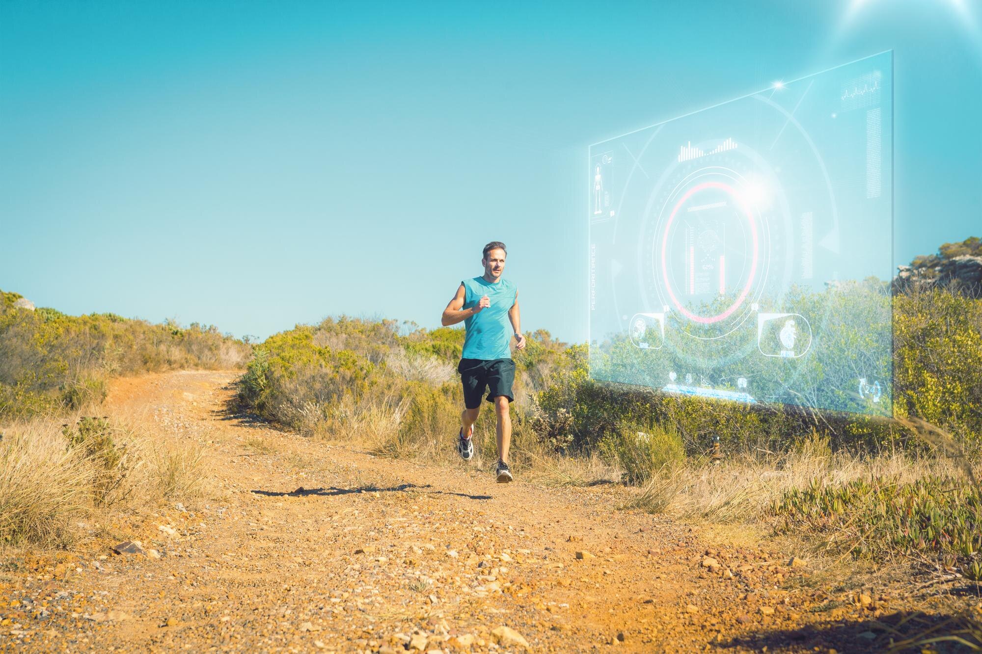 Man jogging on a country trail while wearing a fitness tracker