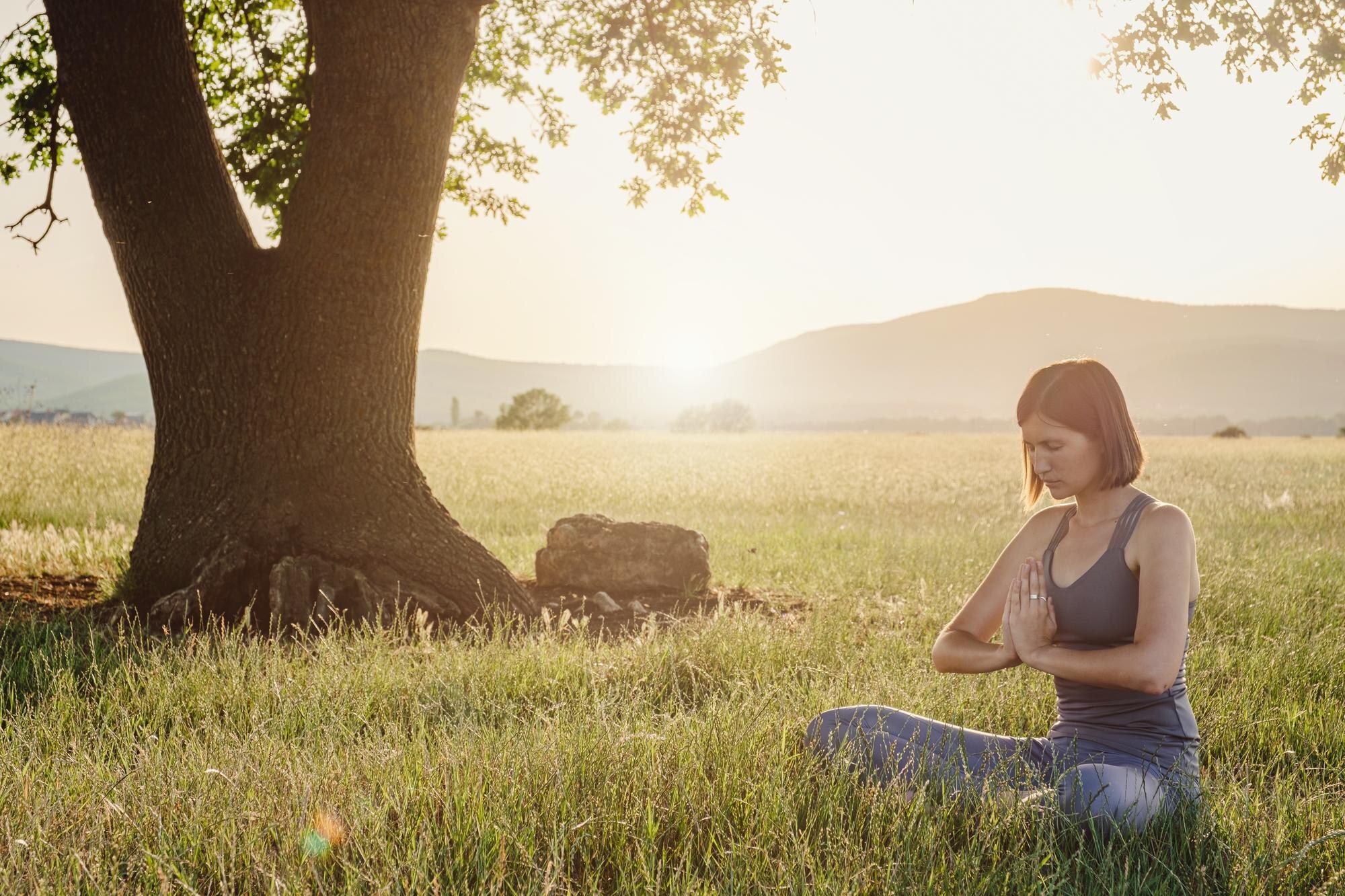 attractive woman practices yoga in nature in summe 64753718630004be7e5f