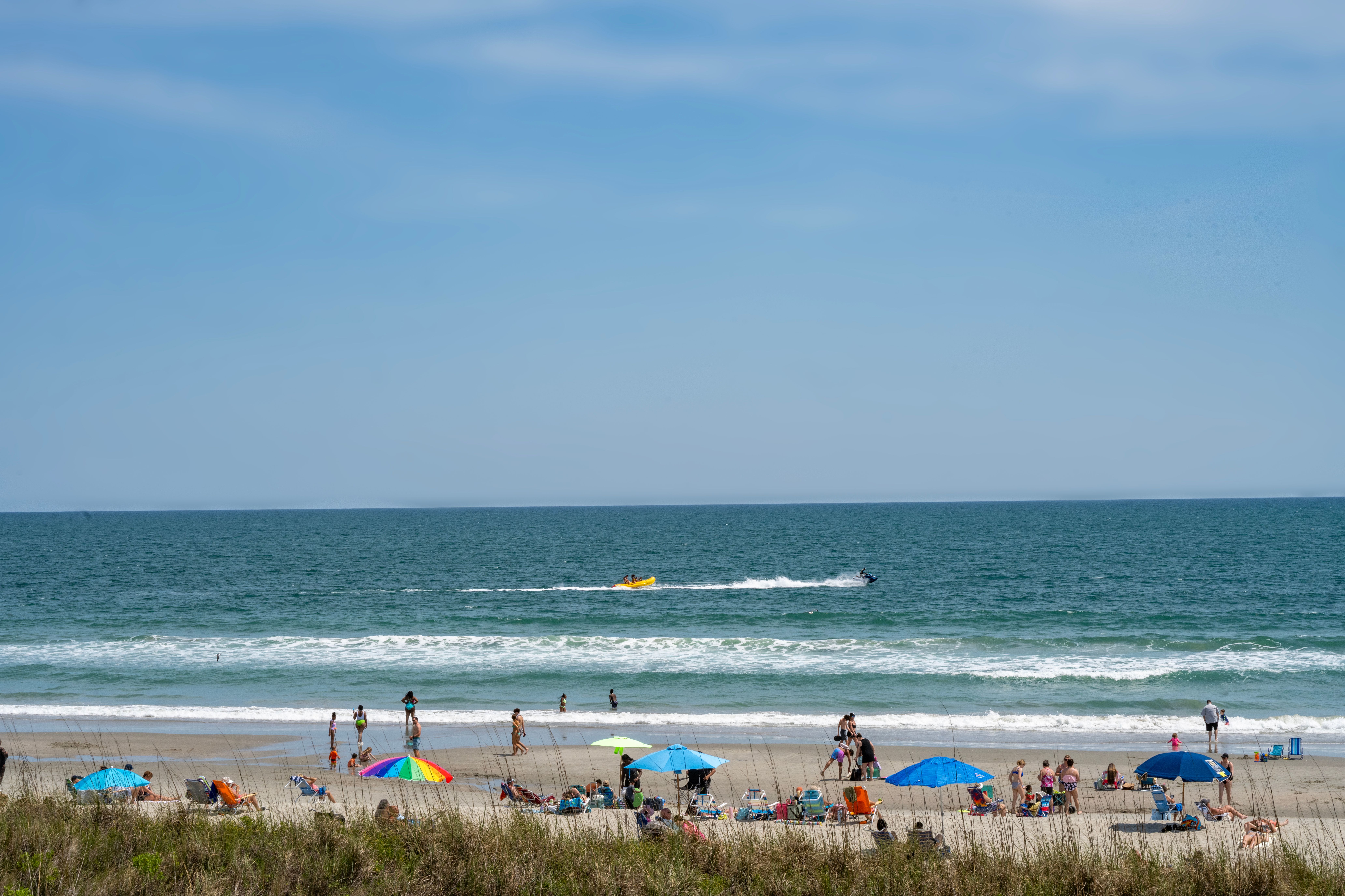 beach day with colorful umbrellas and jet ski 00ddedf7b7f480c77dee