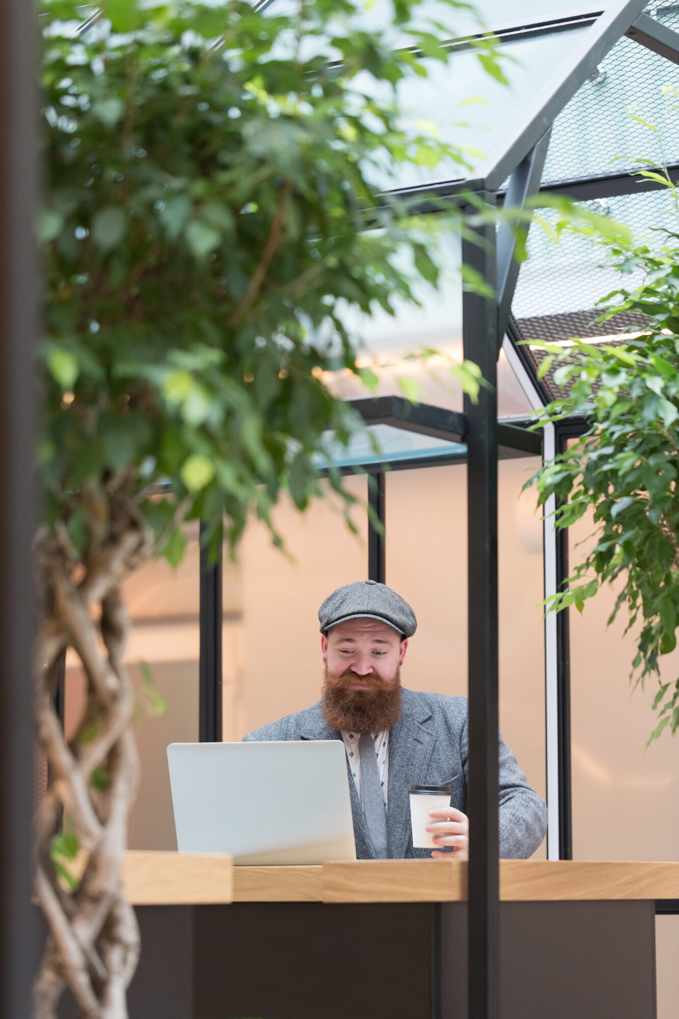 bearded man in wool blazer working on a laptop in dbe98b5265f64b0415d1