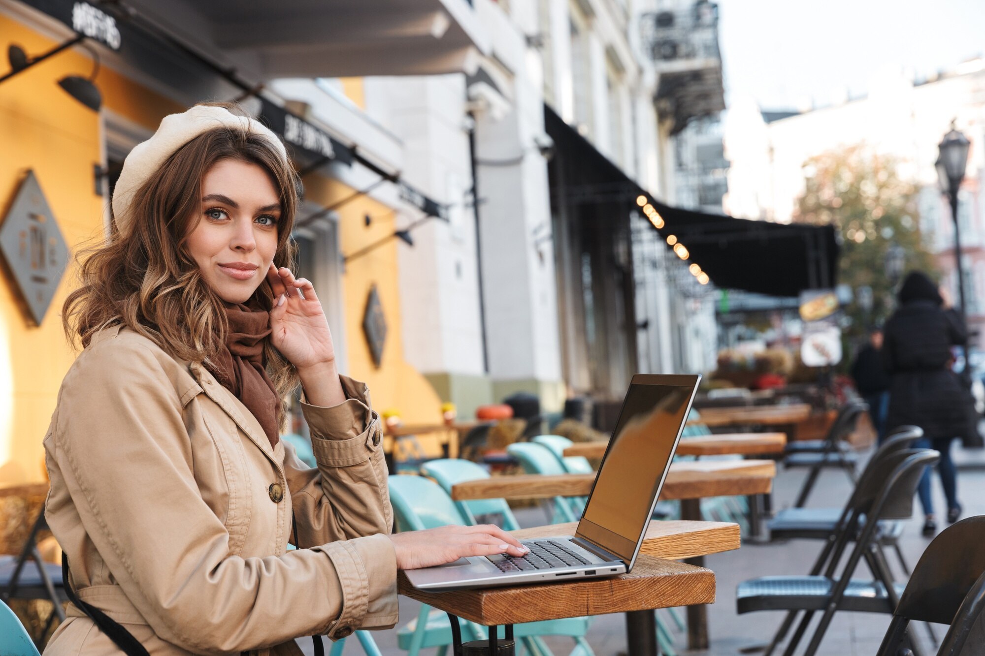 Unlock the World: Work-from-Anywhere Tips for Aspiring Travel Business Owners 1 beautiful young woman wearing a coat using laptop 529b5fef944c23ee9953