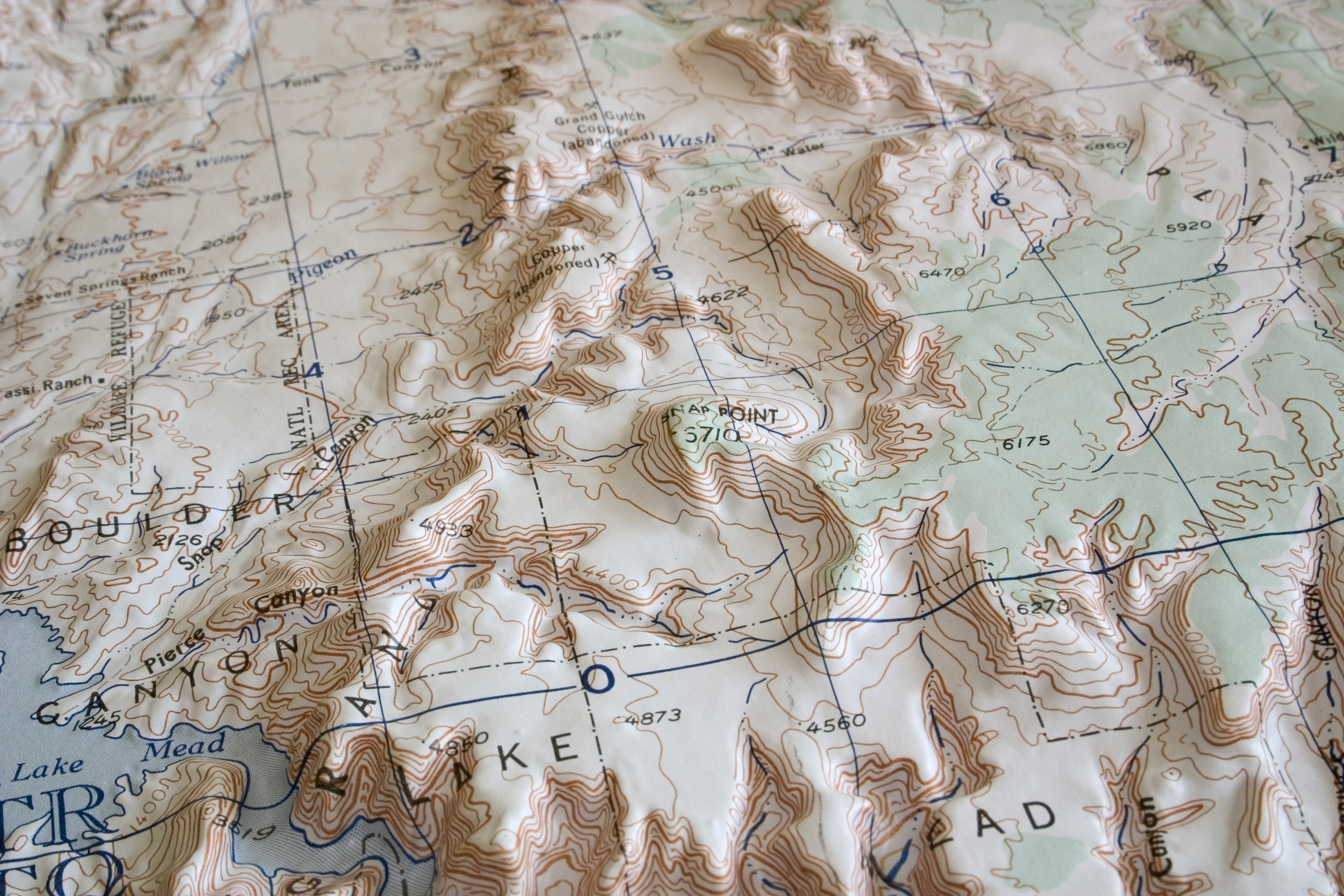 Raised relief map placed on a desk as a conversation piece and memory keepsake