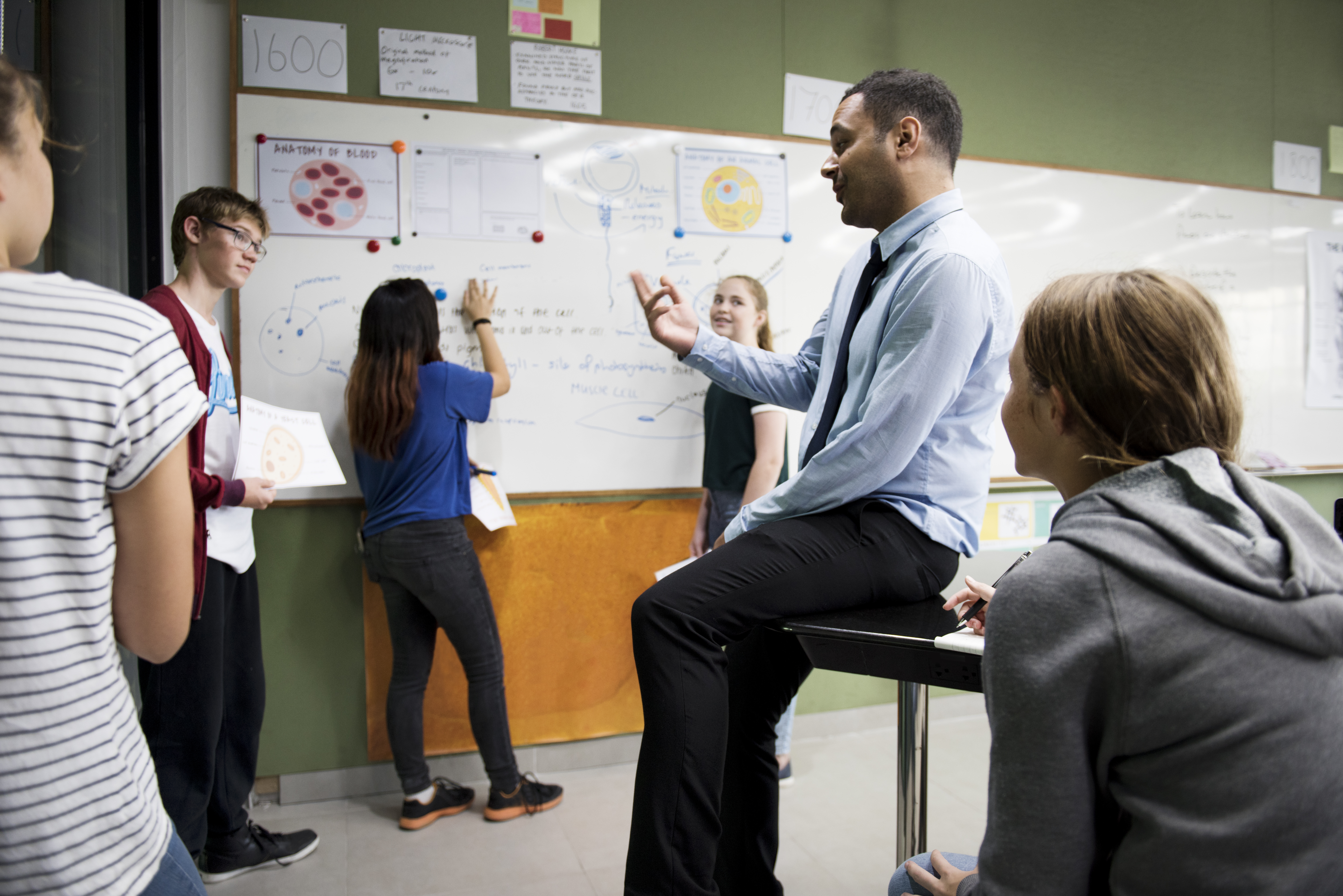 biology teacher teaching in class with diverse of 57e6b48b7e02349d2284