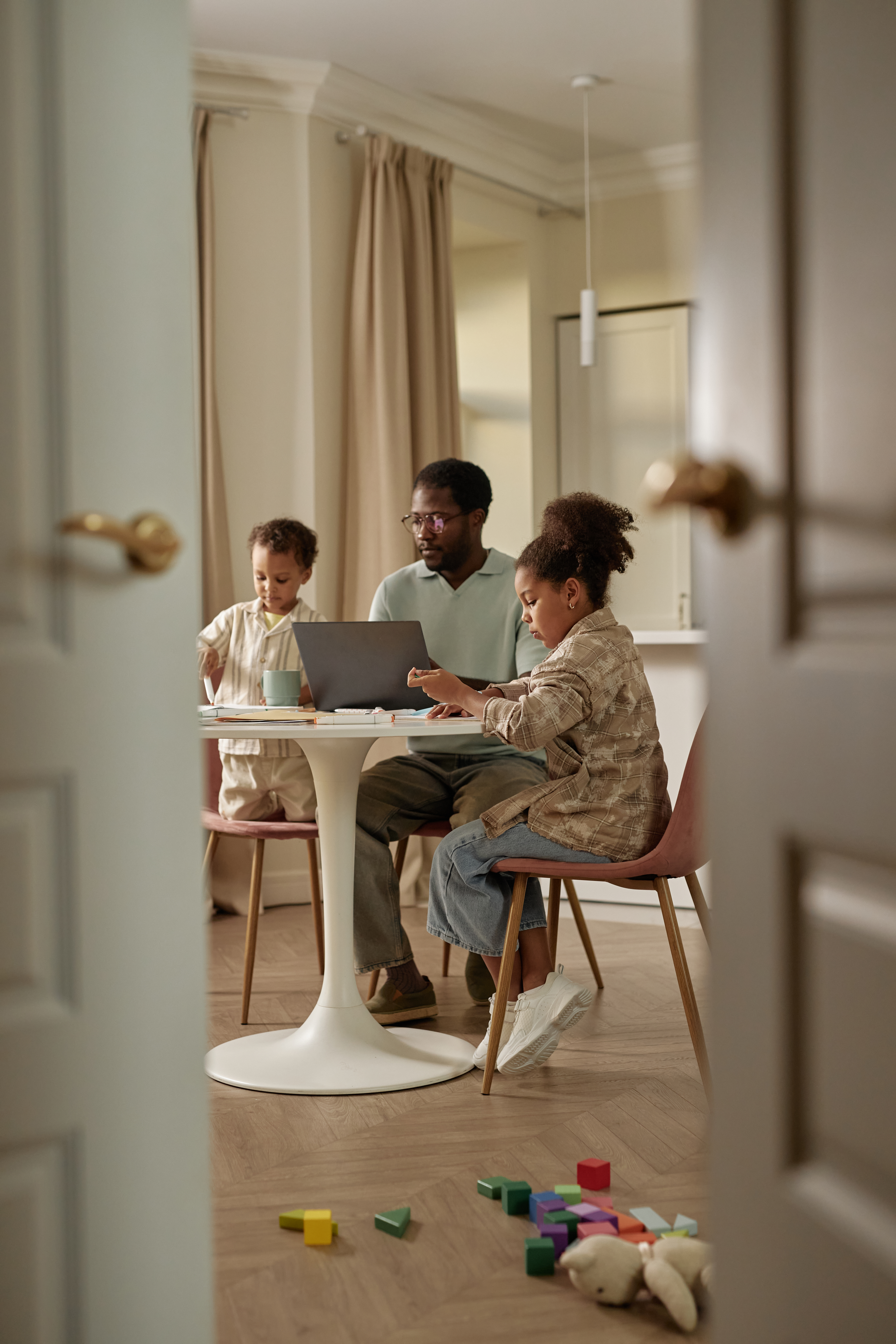 Black Girl Studying At Table Next To Working Dad A 73c7e61c8b56eeb23949