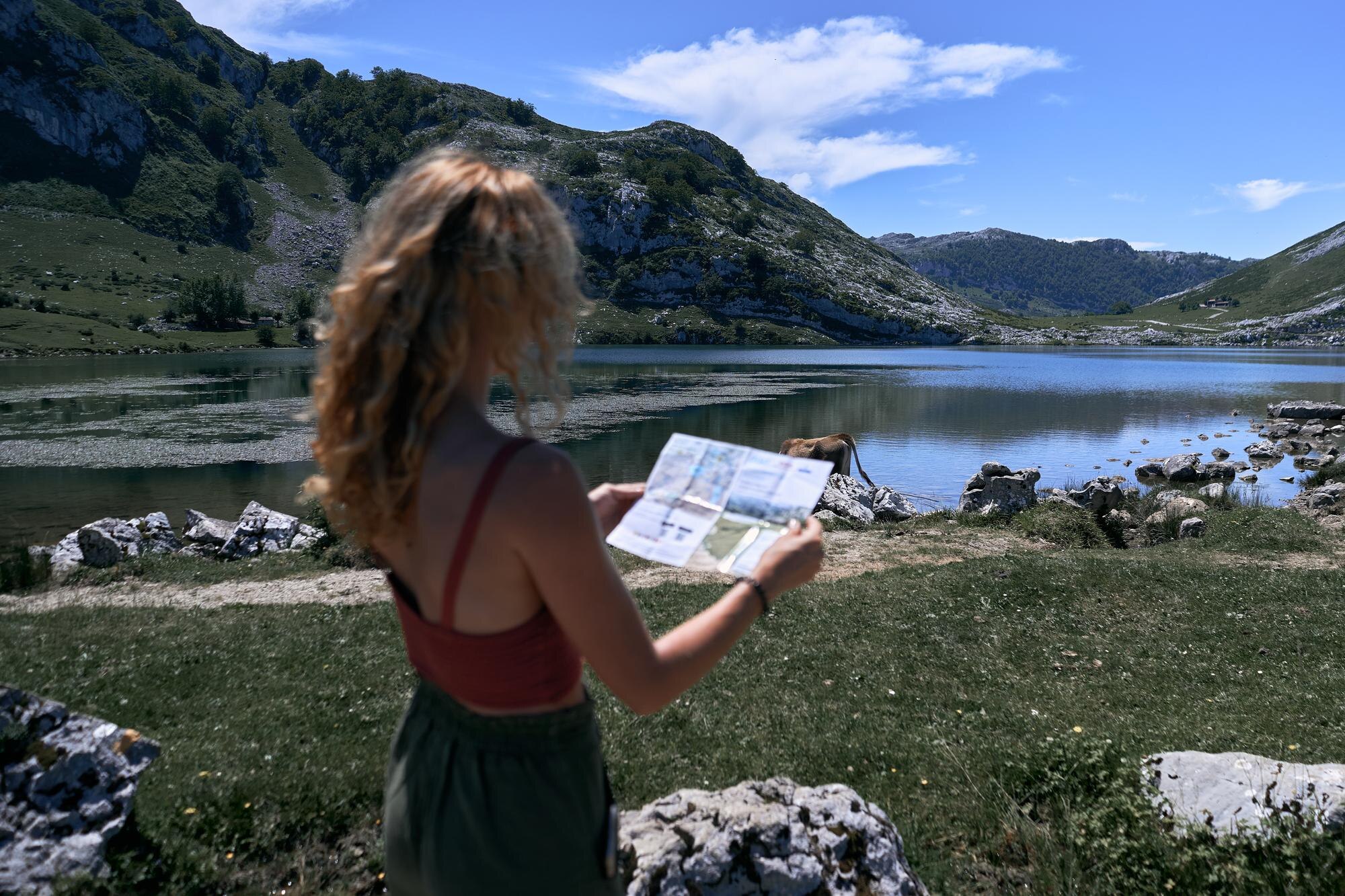 blonde caucasian girl looking at the map near the 5b845be1b41ac9b4e451 BTOURS