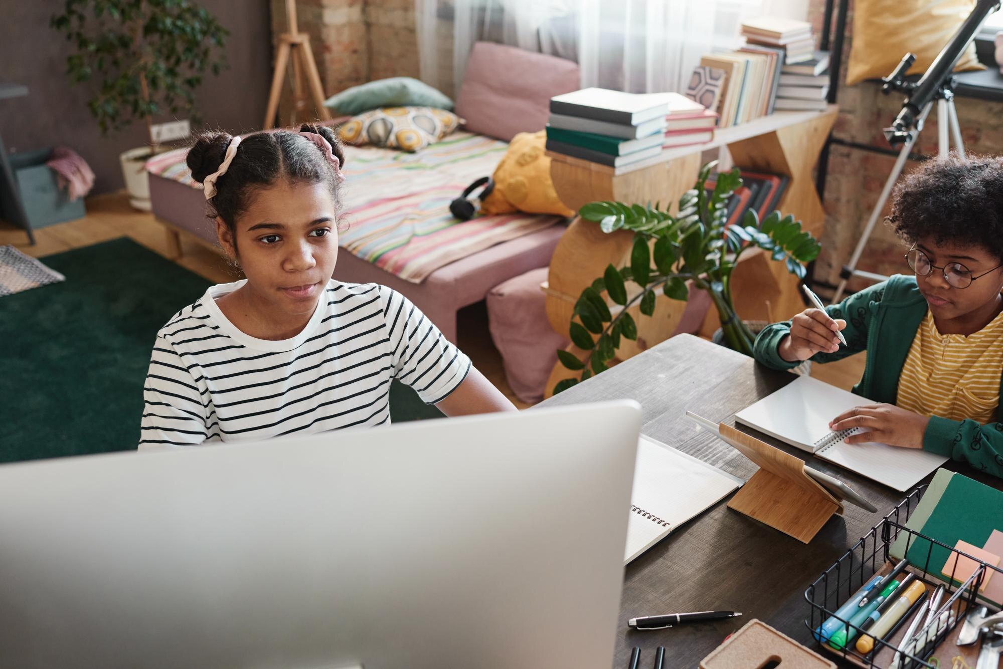 Brother And Sister Preparing For Homework At Home Eac43a09876fc5259a5c