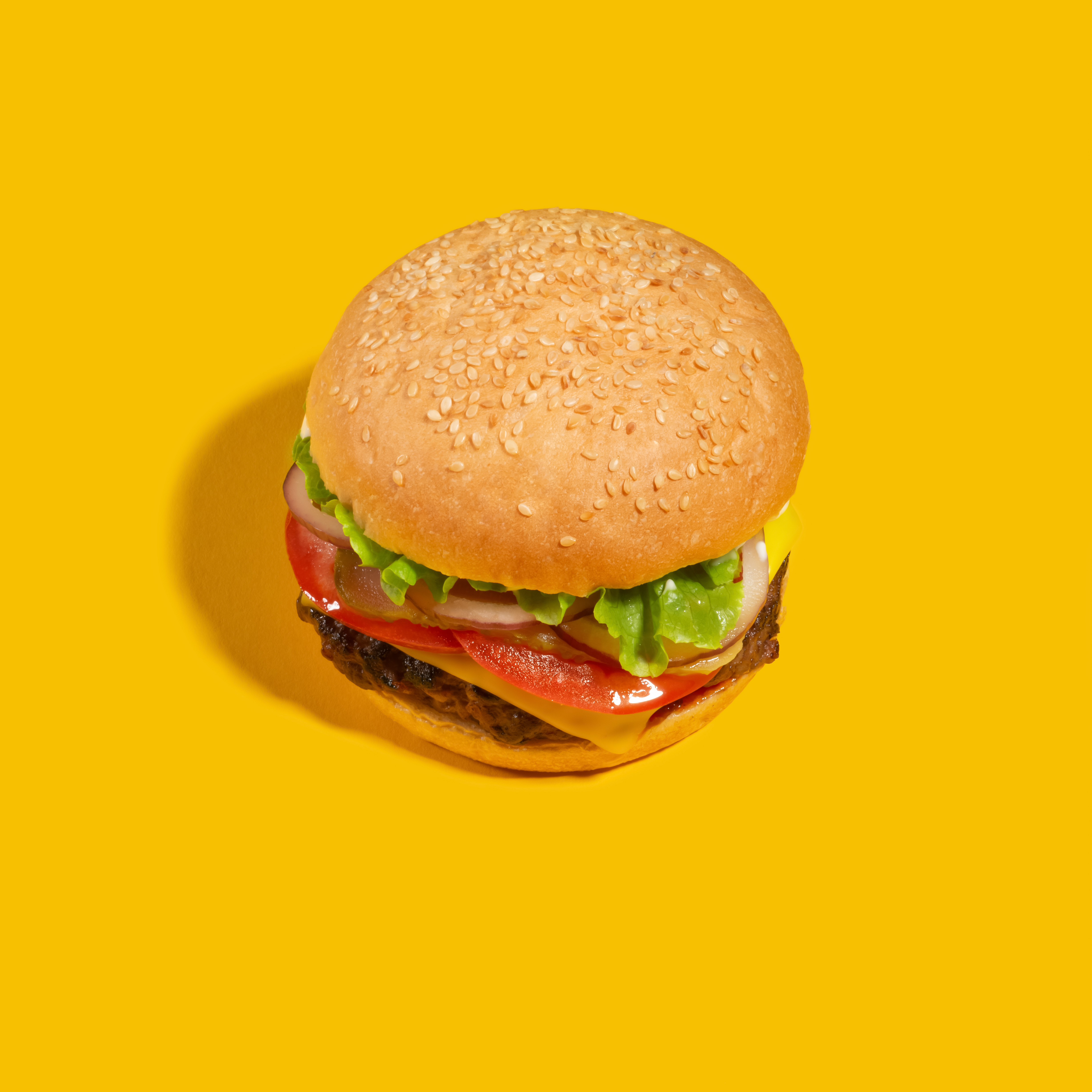 burger on a bright yellow background fd8ac8fdab27d8e4ede4