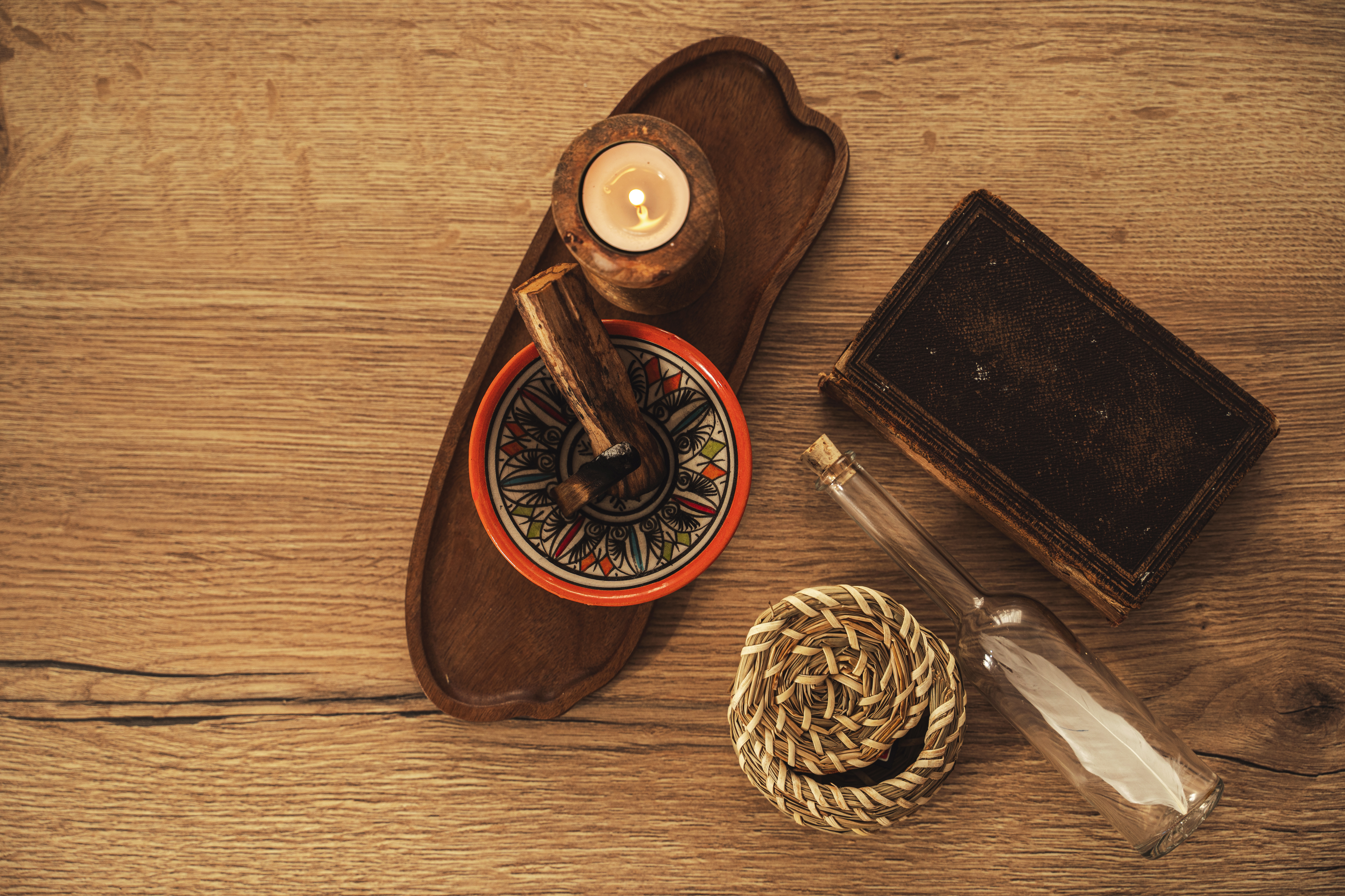 burning palo santo and candle on wooden tray for r 1f8a48e51de72ae0fc47