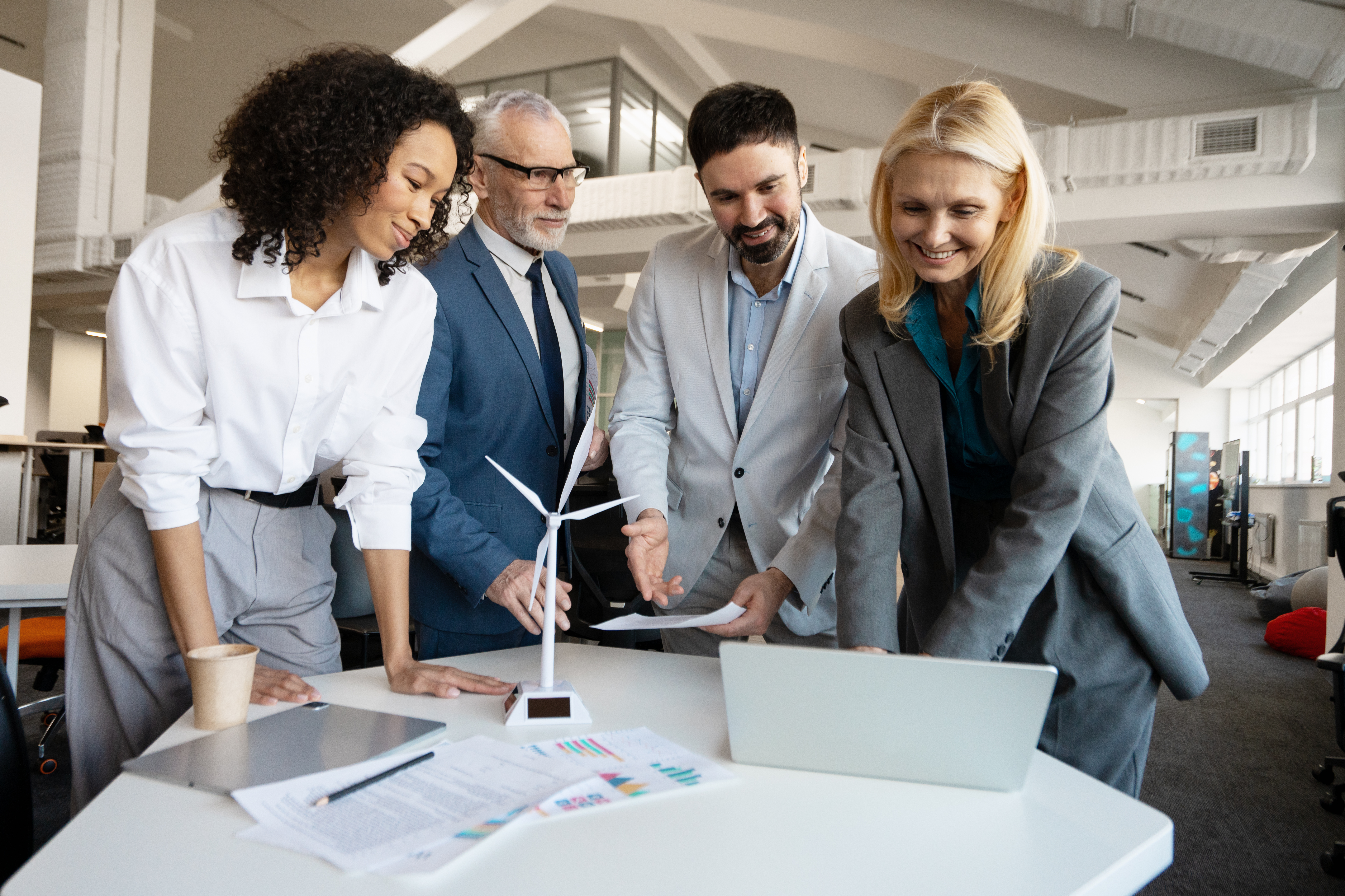 Building Resilience in Energy Teams: Tailored Educational Solutions by GeoModes 3 business people discussing green energy project wi a8ac095dae36125dc62f