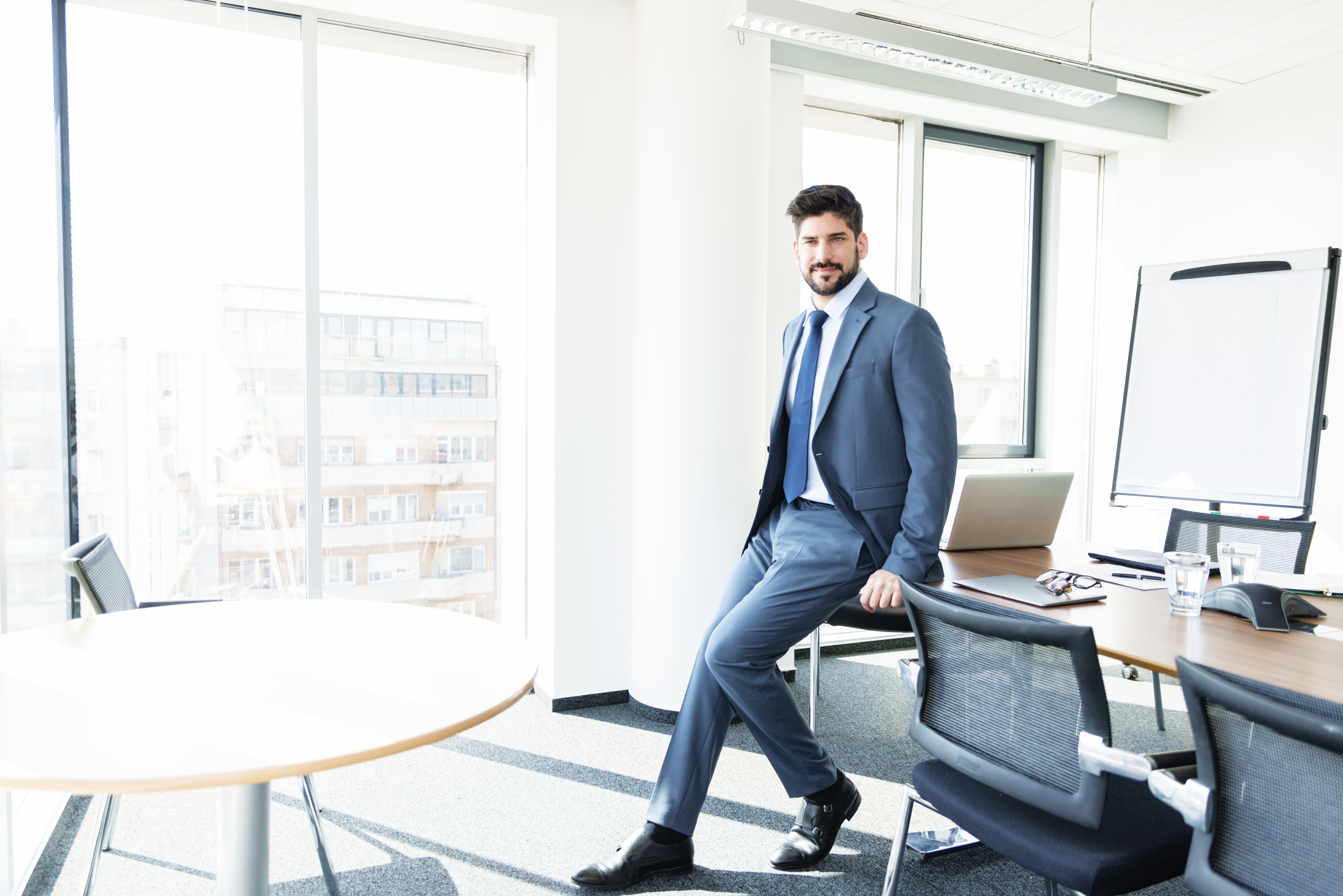 Beyond Skills: The Mindset and Strategy Essential for Successful Career Transitions in Energy 2 businessman standing in a modern office b95f80adbf73ee0d2d9a