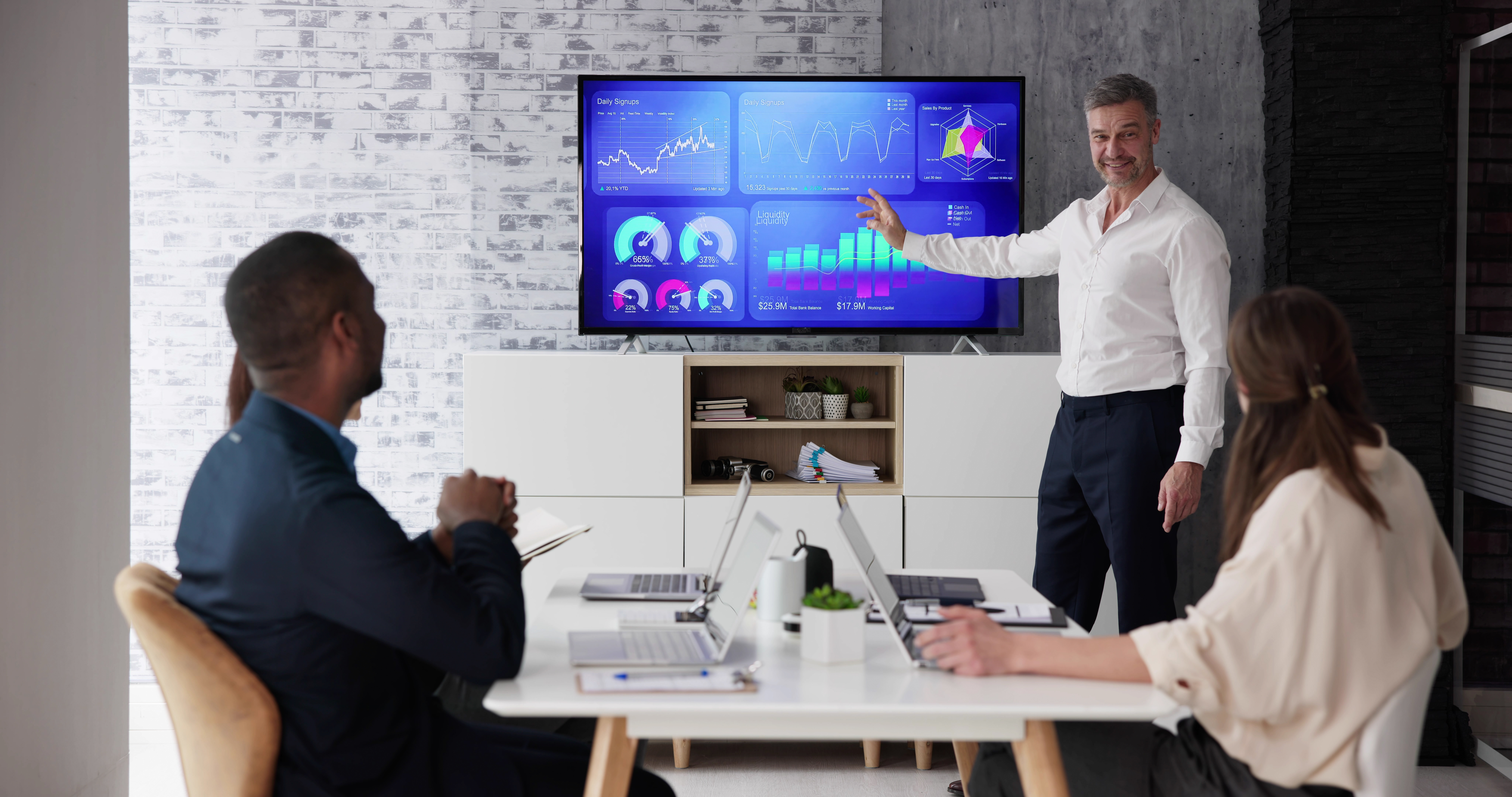 businesspeople looking at businessman giving prese 73302dd35f96b1be65c7